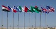 The national flags of Egypt, France, Greece, Italy, Jordan, Saudi Arabia, United Arab Emirates, United Kingdom, and the United States wave in front of the Mohamed Naguib Military Base auditorium after the Exercise Bright Star 2018 opening ceremony, Sept. 8.