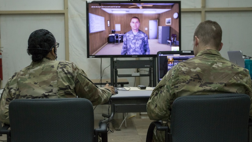 U.S. Army Master Sgt. Breyda Pereyra, left, the noncommissioned officer in charge of U.S. Army Central's G37 office, and U.S. Army Capt. Jordan Smith, the outgoing officer in charge of the U.S. Army Central Readiness Training Center, speak with a virtual Soldier avatar in an Intelligence and Electronic Warfare Tactical Proficiency Trainer program designed to simulate a conversation with a Soldier having suicidal thoughts, Camp Buehring, Kuwait, Sept. 12, 2018. Suicide prevention is an enduring goal of the U.S. Army to ensure the safety and well-being of all Soldiers, Department of the Army civilians, and contractors.