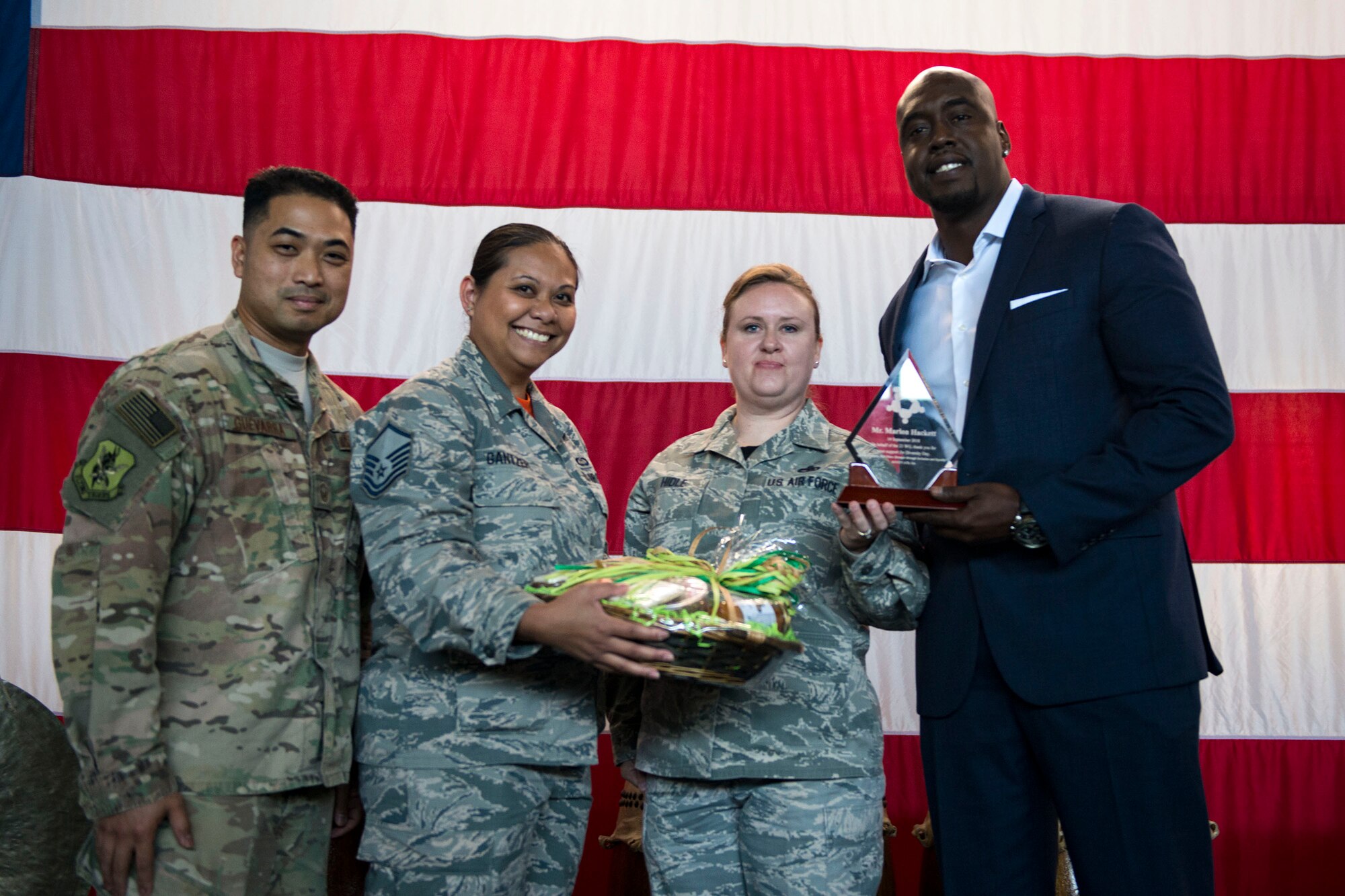 Retired Senior Master Sgt. Marlon Hackett, right, and members of Team Moody pose for a photo during the 23d Wing Diversity Day, Sept. 14, 2018, at Moody Air Force Base, Ga. Diversity Day honored the cultures of all groups and organizations observed by the Department of Defense using forms of expression such as poems and native dances. The theme of this year was ’Many Cultures, One Voice: Stronger Through Inclusion And Equality’. (U.S. Air Force photo by Airman 1st Class Erick Requadt)