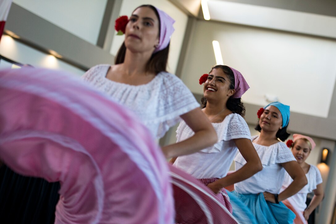 Members from Team Moody perform the Colombian Cumbia during the 23d Wing Diversity Day, Sept. 14, 2018, at Moody Air Force Base, Ga. Diversity Day honored the cultures of all groups and organizations observed by the Department of Defense using forms of expression such as poems and native dances. The theme of this year was ’Many Cultures, One Voice: Stronger Through Inclusion And Equality’. (U.S. Air Force photo by Airman 1st Class Erick Requadt)