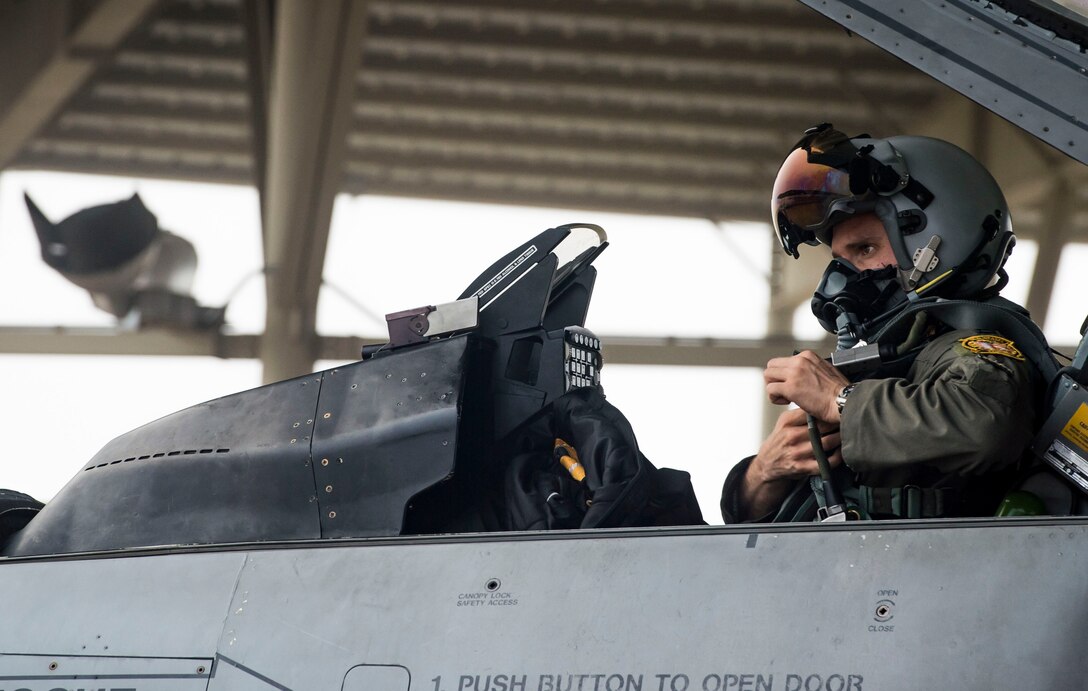U.S. Air Force Capt. Tyler D’Agostino, 79th Fighter Squadron F-16 pilot, fastens his flight gear prior to departing Shaw Air Force Base, S.C., Sept. 12, 2018.