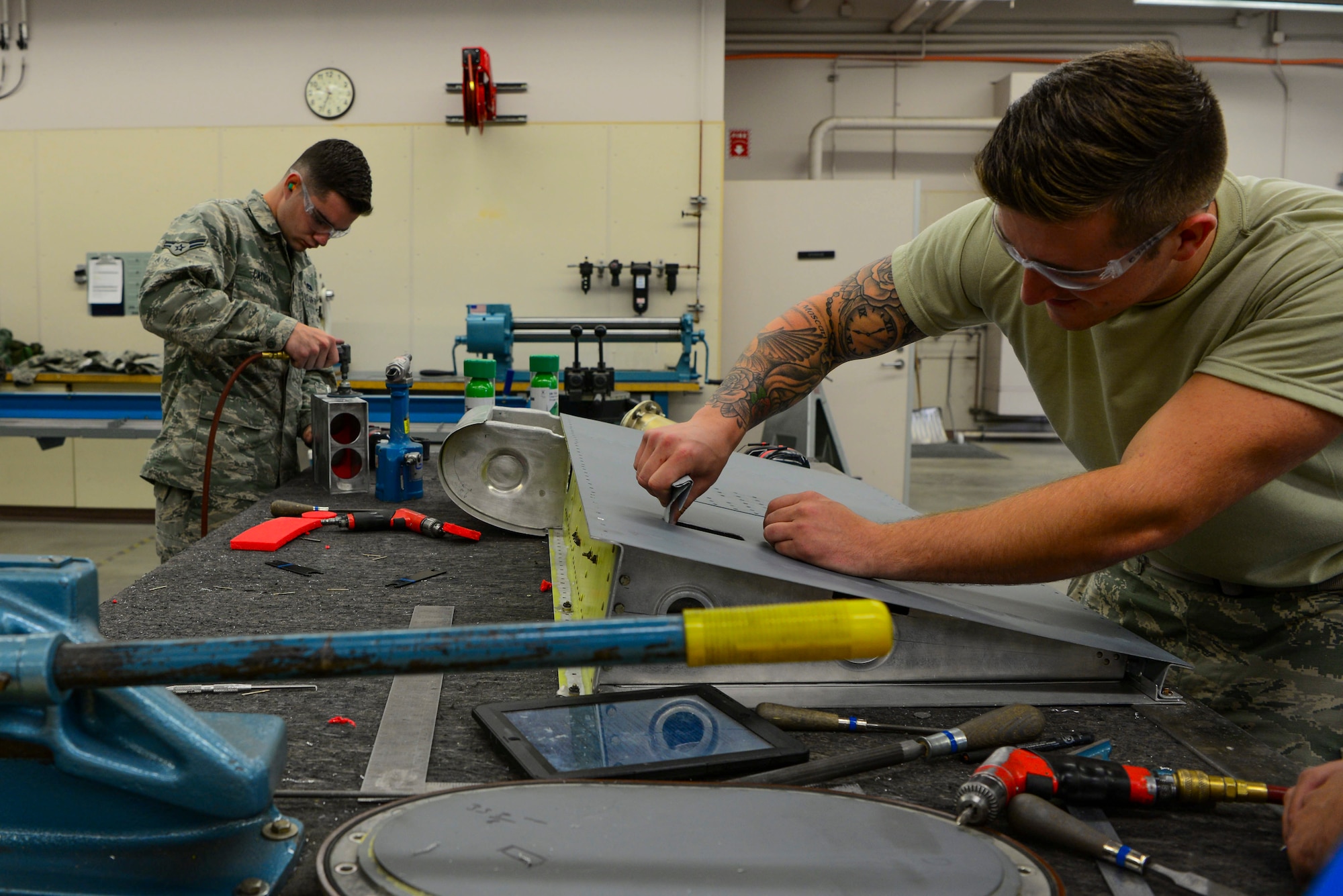 U.S. Air Force Airmen from the 168th Aircraft Maintenance Squadron, assesses damage on an aircraft part Sept. 7, 2018, on Eielson Air Force Base, Alaska. Aircraft structural mechanics modify and alter aircraft parts according to the desired engineering specifications.(U.S. Air Force photo by Airman Aaron Guerrisky)