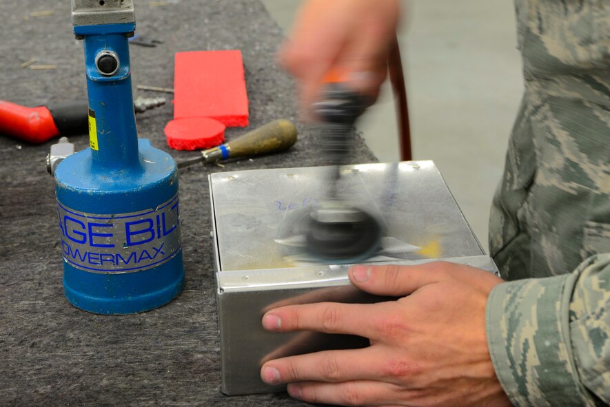 U.S. Air Force Airmen from the 168th Aircraft Maintenance Squadron, assesses damage on an aircraft part Sept. 7, 2018, on Eielson Air Force Base, Alaska. Aircraft structural mechanics modify and alter aircraft parts according to the desired engineering specifications.(U.S. Air Force photo by Airman Aaron Guerrisky)