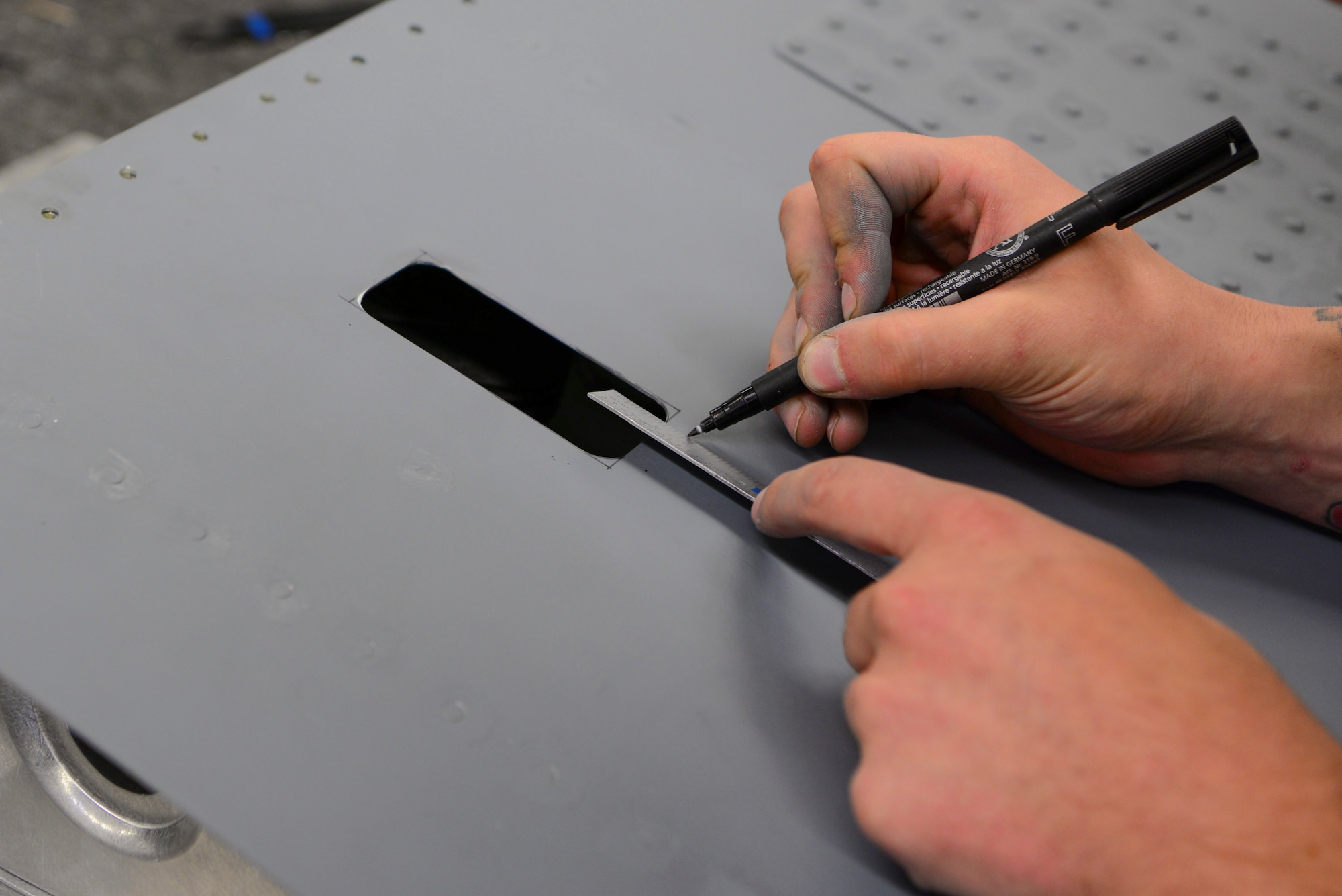 U.S. Air Force Airmen from the 168th Aircraft Maintenance Squadron, assesses damage on an aircraft part Sept. 7, 2018, on Eielson Air Force Base, Alaska. Aircraft structural mechanics modify and alter aircraft parts according to the desired engineering specifications.(U.S. Air Force photo by Airman Aaron Guerrisky)