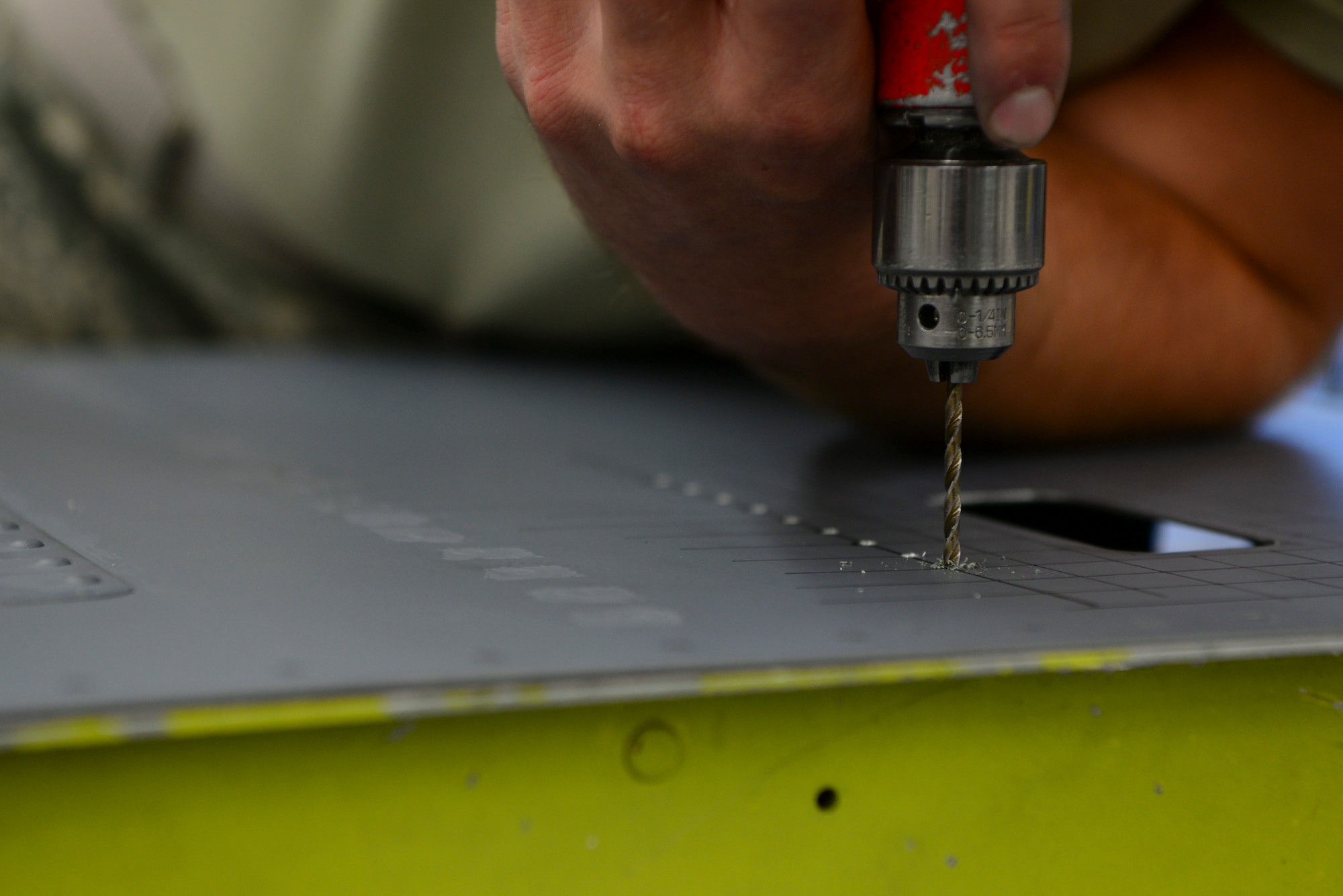 U.S. Air Force Airmen from the 168th Aircraft Maintenance Squadron, assesses damage on an aircraft part Sept. 7, 2018, on Eielson Air Force Base, Alaska. Aircraft structural mechanics modify and alter aircraft parts according to the desired engineering specifications.(U.S. Air Force photo by Airman Aaron Guerrisky)