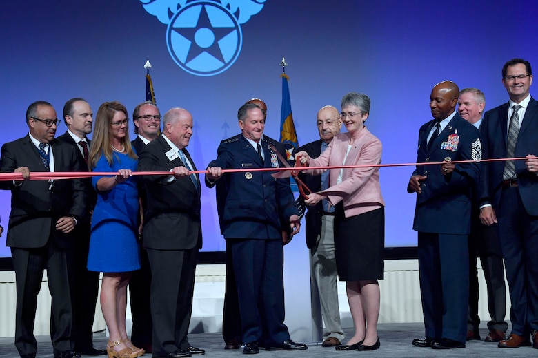Secretary of the Air Force Heather Wilson, Air Force Chief of Staff Gen. David L. Goldfein, Chief Master Sgt. of the Air Force Kaleth O. Wright and Air Force Association leadership cut a ribbon during the 2018 AFA Air, Space and Cyber Conference in National Harbor, Md., Sept. 17, 2018. Cutting the ribbon symbolized the opening of the conference's exhibition hall. (U.S. Air Force photo by Wayne Clark)