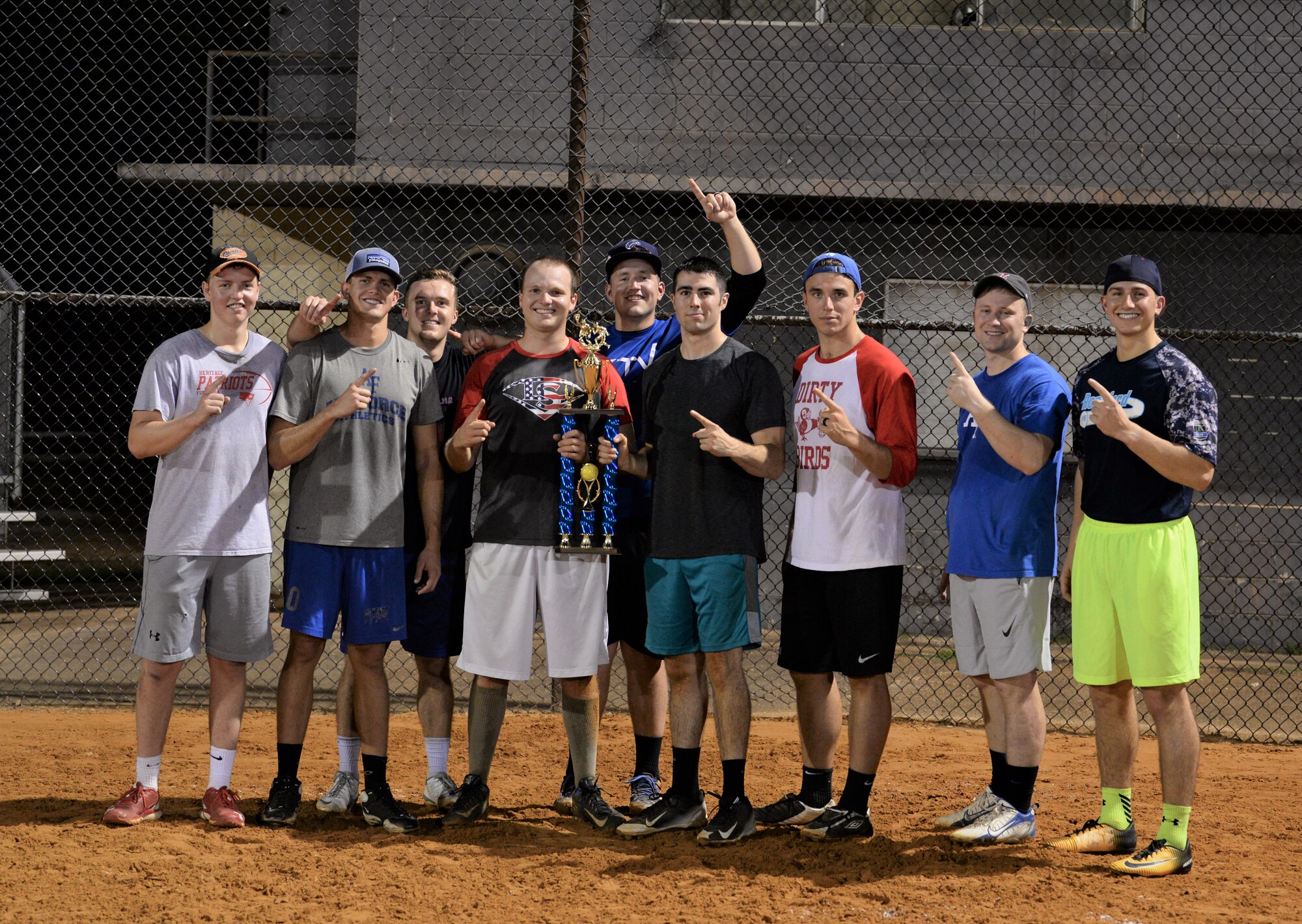 The 50th Flying Training Squadron softball team stands with the trophy Sept. 11, 2017, on Columbus Air Force Base, Mississippi, after beating the 14th Medical Group in the Intramural Softball Championship. The 50th Flying Training Squadron won the second of two games and the championship with a score of 12-1 against the 14th Medical Group. (U.S. Air Force photo by Airman Hannah Bean)