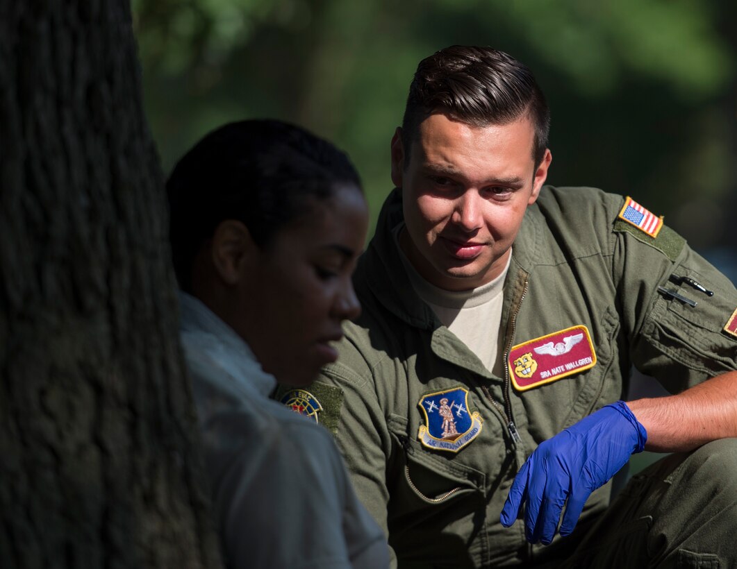 U.S. Air Force Senior Airman Nate Wallgren, right, an emergency medical technician from the 109th Aeromedical Squadron, listens to a role-player’s complaints in St. Paul, Minn., Aug. 16, 2018.