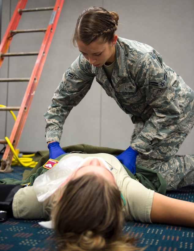 U.S. Air Force Airman 1st Class Victoria Mook, an emergency medical technicians from 192nd Medical Group, DET 1, checks a role-player for injuries in St. Paul, Minn., Aug. 17, 2018.