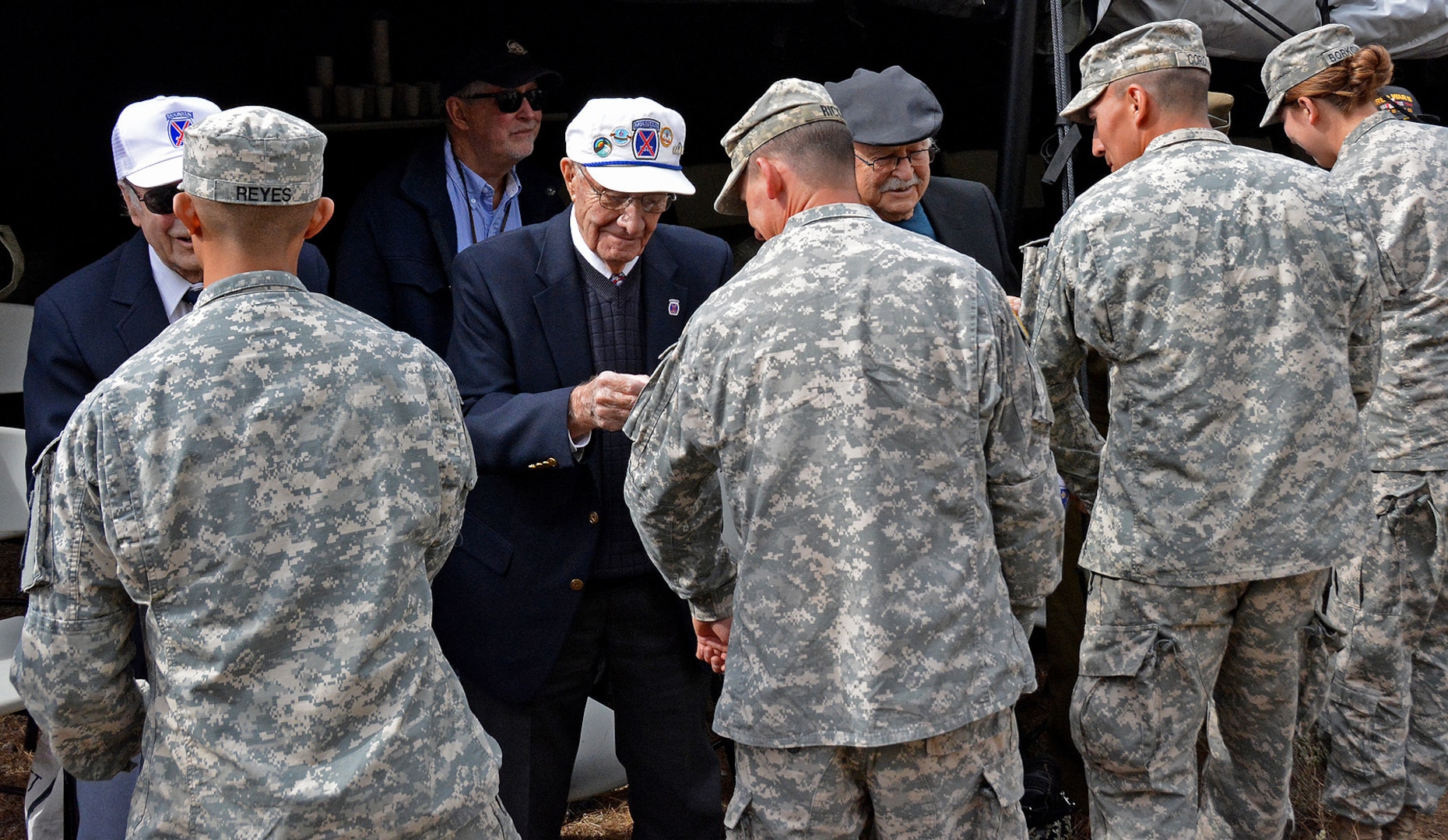 Several 10th Mountain Division World War II veterans “patched”  Soldiers of 1st Battalion, 157th Infantry (Mountain), Colorado Army National Guard, during the historic re-patching ceremony at Camp Hale, Colorado Oct. 30, 2016, as the 1-157 IN (MTN) became part of the 10th Mountain Division. The 1-157th assumes its role as one of only three mountain infantry battalions in the U.S. Army, reconnecting the historic 10th Mountain Division to Colorado. (Photo by Army National Guard Staff Sgt. Lalita Laksbergs)
