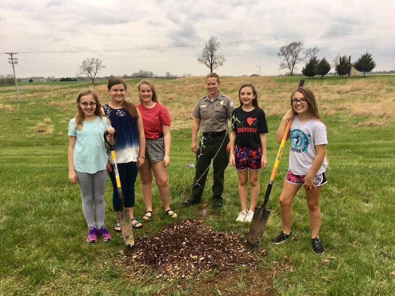 Young volunteers assisted by a park ranger, volunteered to plant a tree at Smithville Lake, Mo.