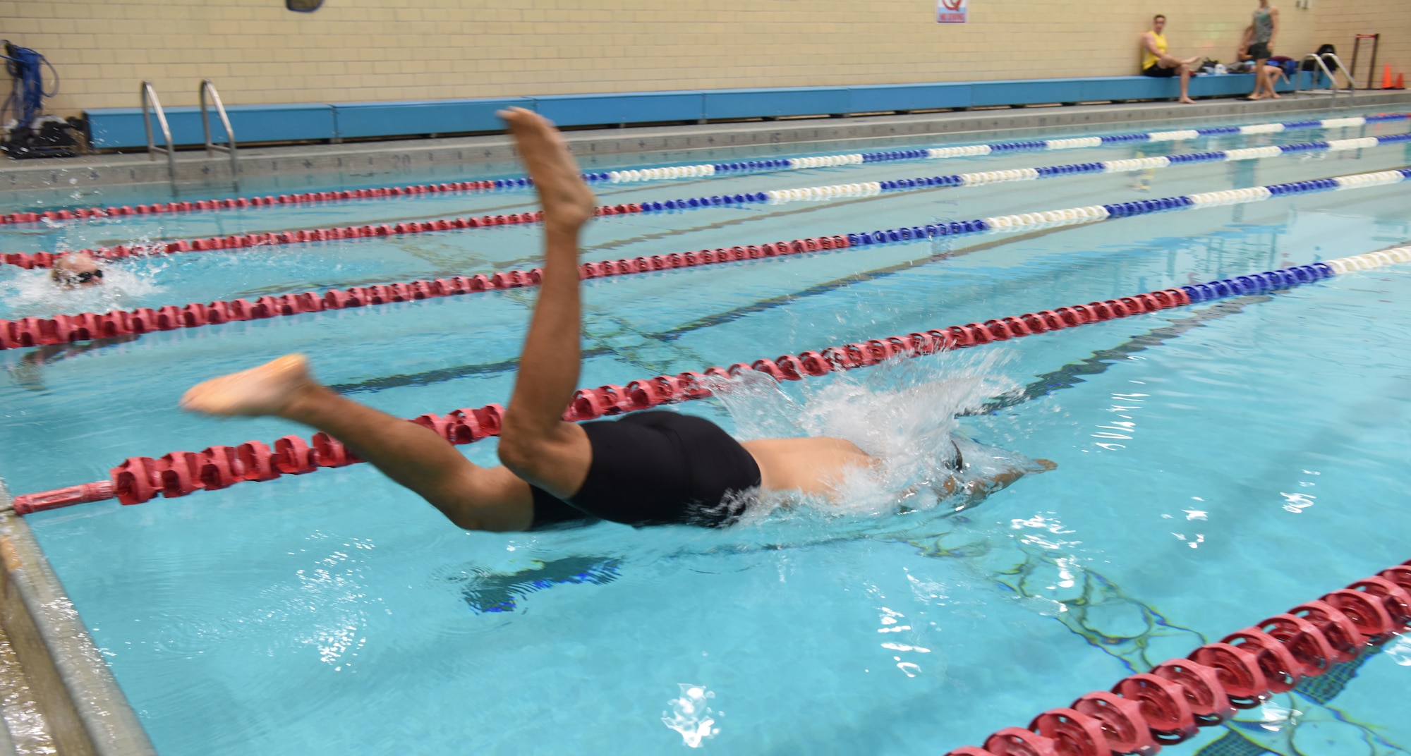 Staff Sgt. Roger Barrett, a 28th Maintenance Squadron aerospace ground equipment technician, dives into a pool at Ellsworth Air Force Base, S.D., Sept. 15, 2018. The 28th Force Support Squadron hosted the tri-to-b1 triathlon, which consisted of a 500-meter swim, a five-kilometer run and a 10-kilometer bicycle ride. (U.S. Air Force Photo by Airman 1st Class Thomas Karol)