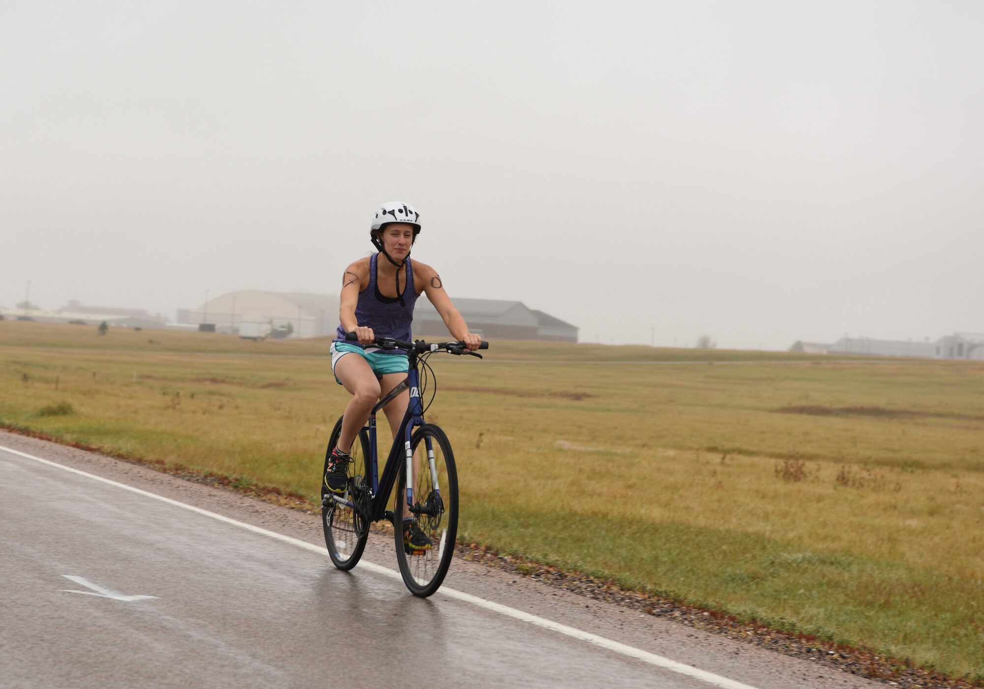 Corrie McFarland, a dependent, rides her bicycle during a triathlon at Ellsworth Air Force Base, S.D., Sept. 15, 2018. The 28th Force Support Squadron hosted the tri-to-b1 triathlon, which consisted of a 500-meter swim, a five-kilometer run and a 10-kilometer bicycle ride. (U.S. Air Force Photo by Airman 1st Class Thomas Karol)