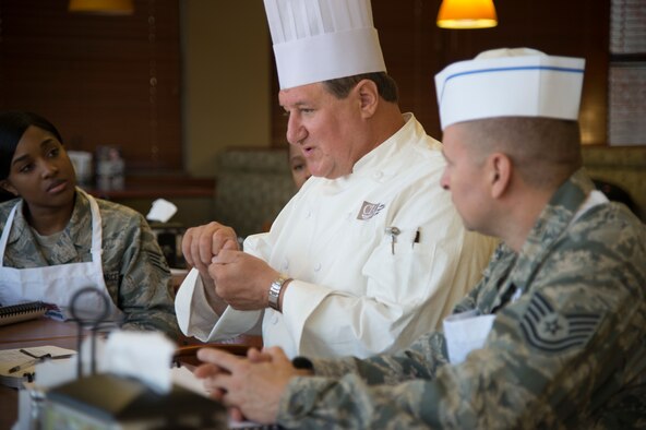 PETERSON AIR FORCE BASE, Colo. – James Hanyzeski, a Culinary Institute of America certified master chef, explains cooking techniques to food service specialists at the Aragon Dining Facility on Peterson Air Force Base, Colorado, Sept. 11, 2018. The food service specialists will use these new skills to better prepare food in alignment with the Department of Defense’s Go for Green initiative. G4G teaches DFAC patrons to make the best food choices to fuel their body. (U.S. Air Force photo by Staff Sgt. Emily Kenney)