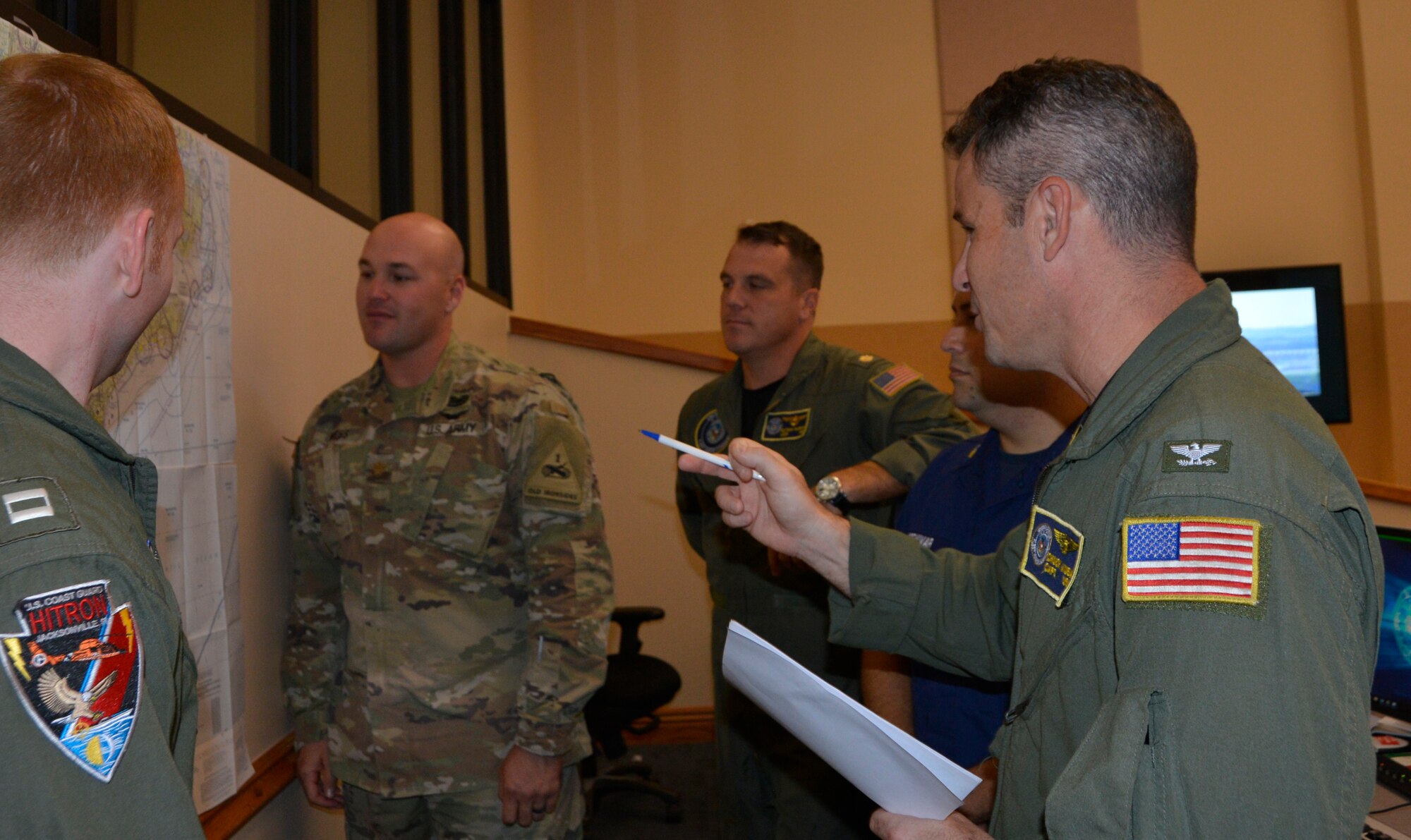 U.S. Navy CAPT. Charles Kuba, Air Forces Northern Search and Rescue Operations Coordination Element Naval Liaison Element, makes a point during a briefing about potential search and rescue operations to assist U.S. Northern Command’s support of the Federal Emergency Management Agency for Hurricane Florence. Total Force representation during AFNORTH’s  Defense Support of Civil Authorities efforts includes active-duty U.S. Navy, U.S. Marine Corps, U.S. Army, U.S. Coast Guard, and U.S. Air Force, Guard, Reservists and civilians. (Air Force photo by Mary McHale)