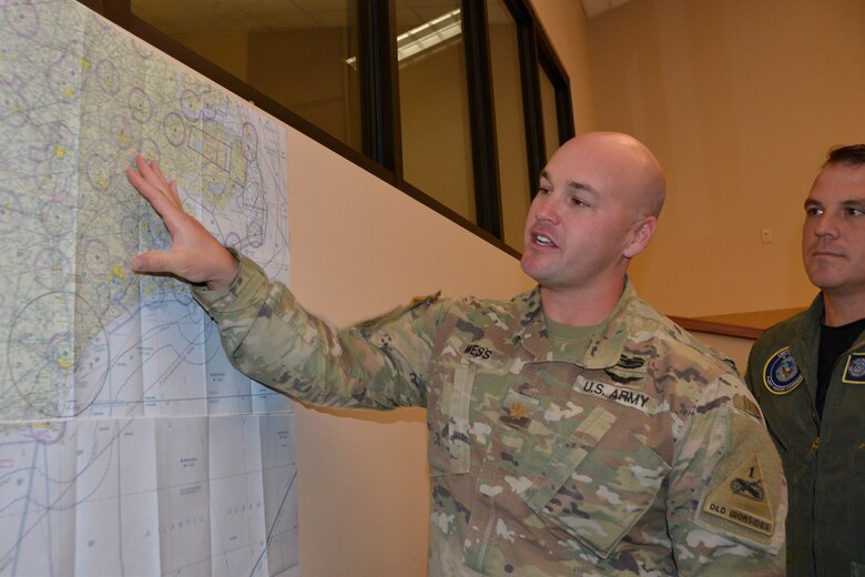U.S. Navy Lt. Cdr. Nathan Kaspar, Air Forces Northern Search and Rescue Operations Coordination Element Naval Liaison Element, watches as U.S. Army Maj. Brandon Wess, U.S. Army Liaison Officer, describes a mapped area where potential search and rescue operations for Hurricane Florence could occur. Total Force representation during AFNORTH’s Defense Support of Civil Authorities efforts includes active-duty U.S. Navy, U.S. Marine Corps, U.S. Army, U.S. Coast Guard, and U.S. Air Force, Guard, Reservists and civilians. (Air Force photo by Mary McHale)