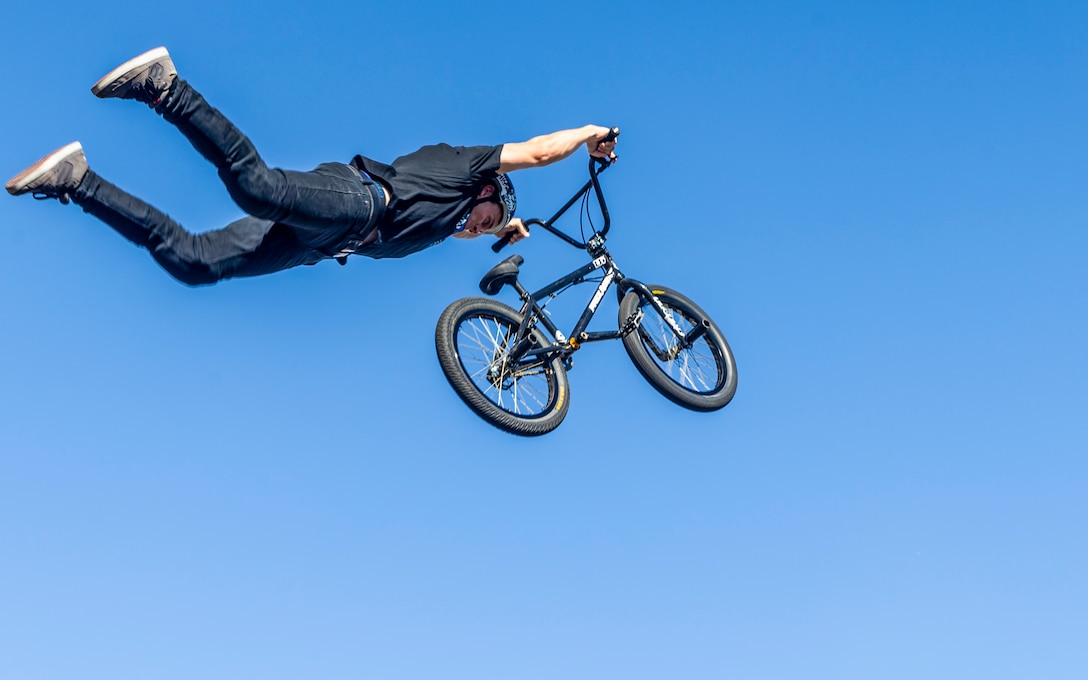 Jared Eberwein, professional BMX rider and X-Games athlete, performs a superman during the X-Games Action Sports Show at the Marine Corps Exchange parking lot aboard the Marine Corps Air Ground Combat Center, Twentynine Palms, Calif., Sept. 8, 2018. The X-Games provided a social recreational event in honor of the continuous service and sacrifice military personnel and family members make for the country. (U.S. Marine Corps photo by Pfc. Robin Lewis)
