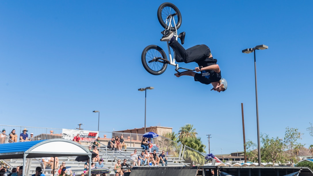 Kole Voelker, professional BMX rider and X-Games athlete, Performs a front flip during the X-Games Action Sports Show at the Marine Corps Exchange parking lot aboard the Marine Corps Air Ground Combat Center, Twentynine Palms, Calif., Sept. 8, 2018. The X-Games provided a social recreational event in honor of the continuous service and sacrifice military personnel and family members make for the country. (U.S. Marine Corps photo by Pfc. Robin Lewis)