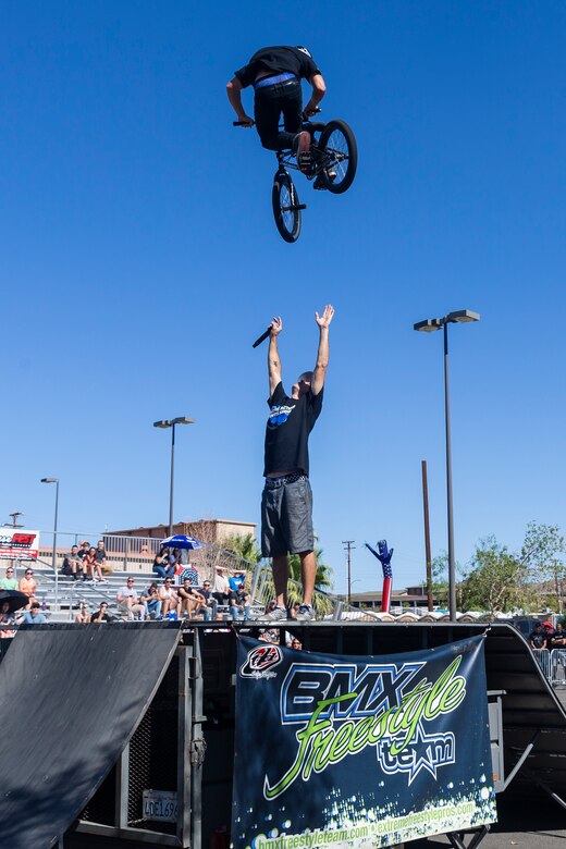 Jared Eberwein, professional BMX rider and X-Games athlete, hits a 540 bar spin over Dustin McCarty, Manager of McCarty BMX Freestyle Team and professional BMX rider, during the X-Games Action Sports Show at the Marine Corps Exchange parking lot aboard the Marine Corps Air Ground Combat Center, Twentynine Palms, Calif., Sept. 8, 2018. The X-Games provided a social recreational event in honor of the continuous service and sacrifice military personnel and family members make for the country. (U.S. Marine Corps photo by Pfc. Robin Lewis)
