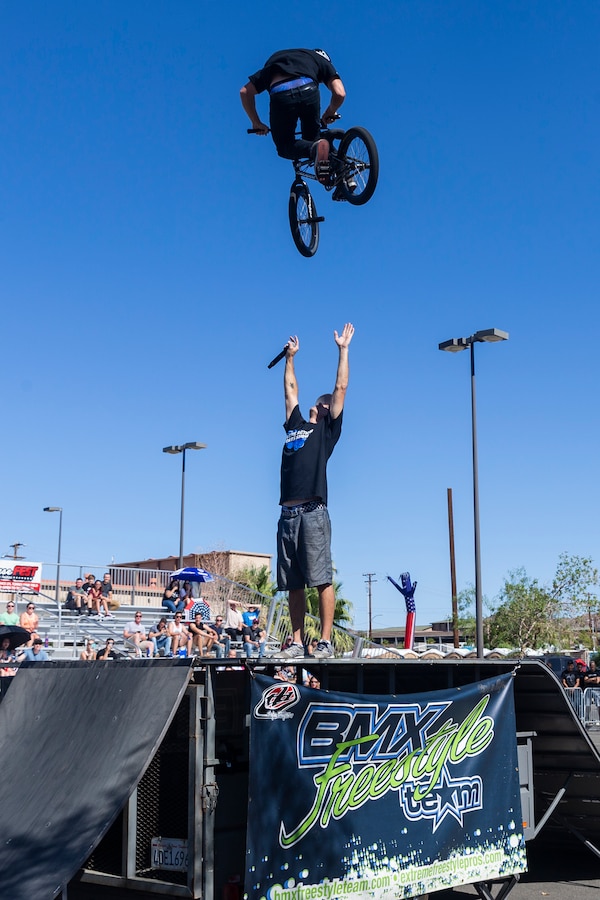 Jared Eberwein, professional BMX rider and X-Games athlete, hits a 540 bar spin over Dustin McCarty, Manager of McCarty BMX Freestyle Team and professional BMX rider, during the X-Games Action Sports Show at the Marine Corps Exchange parking lot aboard the Marine Corps Air Ground Combat Center, Twentynine Palms, Calif., Sept. 8, 2018. The X-Games provided a social recreational event in honor of the continuous service and sacrifice military personnel and family members make for the country. (U.S. Marine Corps photo by Pfc. Robin Lewis)