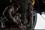 Master Sgt. Jim Brucculeri and Staff Sgt. Kareem Spearman from the 102nd Rescue Squadron, New York Air National Guard, scan for people in need of rescue over Kinston, N.C. Sept. 16, 2018.