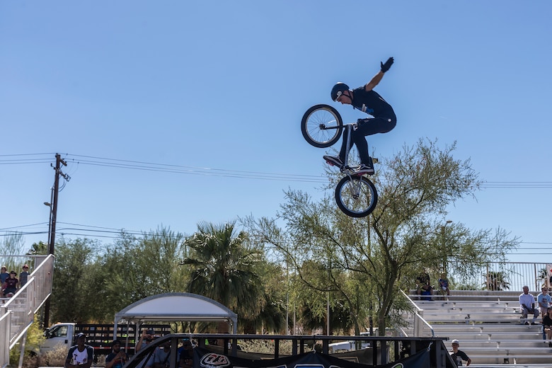 Seth Riley, professional BMX rider and X-Games athlete, performs a tuck no hander during the X-Games Action Sports Show at the Marine Corps Exchange parking lot aboard the Marine Corps Air Ground Combat Center, Twentynine Palms, Calif., Sept. 8, 2018. The X-Games provided a social recreational event in honor of the continuous service and sacrifice military personnel and family members make for the country. (U.S. Marine Corps photo by Pfc. Robin Lewis)