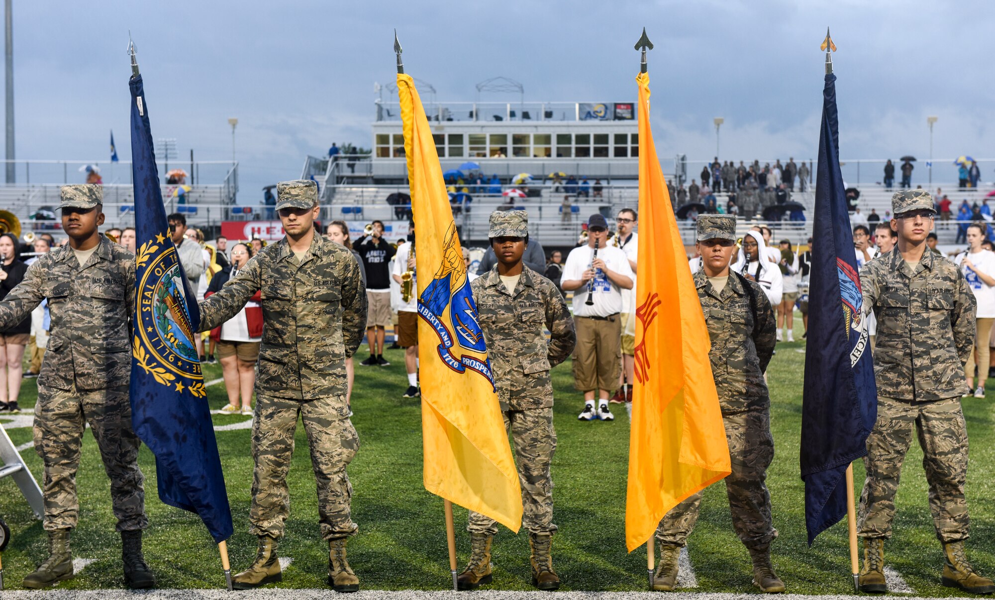 Goodfellow volunteers stand with all 50 flags of the U.S. during the half-time ceremony for Military Appreciation Day, at the LeGrand stadium, in San Angelo, Texas, Sept. 15, 2018. The volunteers converged at the 50-yard line while the Ram Band played the military service songs. (U.S. Air Force photo by Aryn Lockhart/Released)