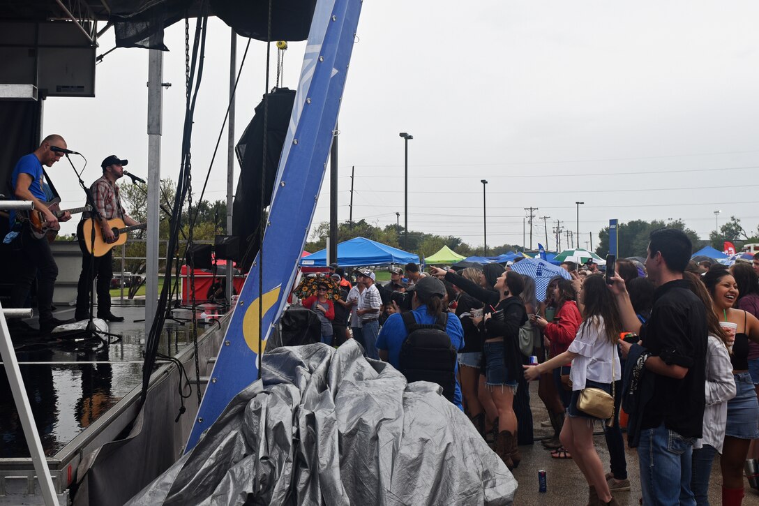 Those willing to endure the rain were able to listen to Wade Bowen perform during the Ram Jam segment of the Military Appreciation Day at the LeGrand Alumni and Visitor’s Center, in San Angelo, Texas, Sept. 15, 2018. The Ram Jam also offered free food and a place to socialize before the start of the Angelo State University football game. (U.S. Air Force photo by Airman 1st Class Zachary Chapman/Released)