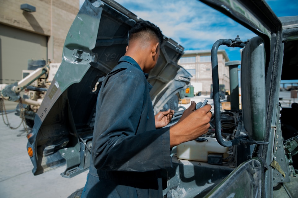 A Marine with the maintenance section, Headquarters and Service Company, 1st Tank Battalion, checks the oil level of a Humvee at the 1st Tank Battalion ramp aboard the Marine Corps Air Ground Combat Center, Twentynine Palms Calif., August 29, 2018.  Motor Transport Marines with 1st Tank Battalion increased overall readiness by 20% in the past three weeks by working extended hours. (Photo by Lance Cpl. Carley Vedro)