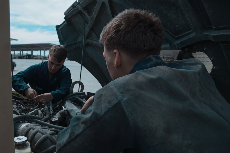 Marines with H&S Company, 1st Tank Battalion, conduct a routine check of the quality under the hood of a Humvee on the 1st Tank Battalion ramp aboard the Marine Corps Air Ground Combat Center, Twentynine Palms Calif., August 29, 2018. Motor Transport Marines with 1st Tank Battalion increased overall readiness by 20% in the past three weeks by working extended hours. (Photo by Lance Cpl. Carley Vedro)