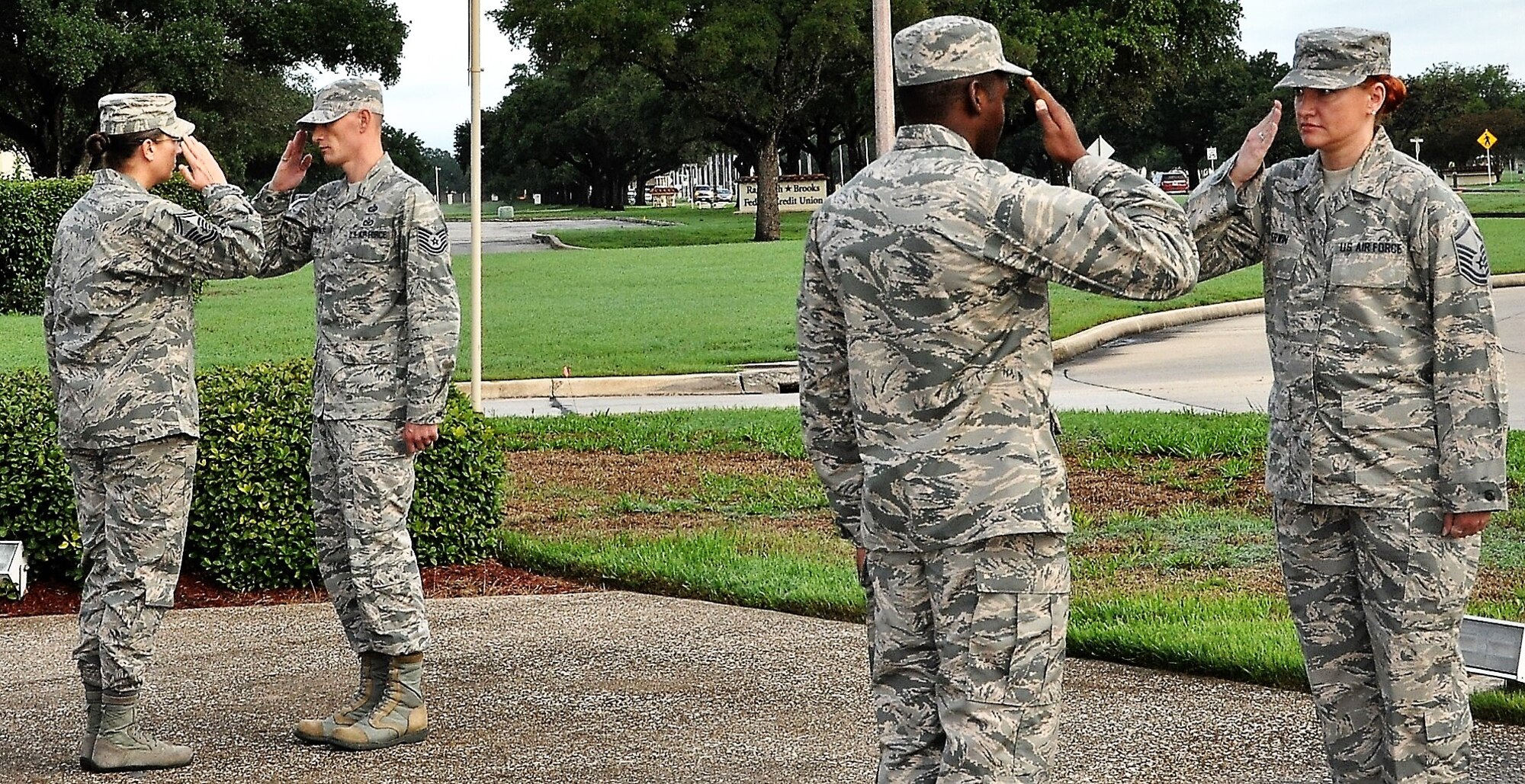 Master Sgt. Melissa Erwin, 340th Flying Training Group (far right) salutes the outgoing Airman as she prepares for her 30-minute stint during the POW\MIA Recognition Week Missing Man Vigil held Sept. 17 at Joint Base San Antonio-Randolph, Texas. (U.S. Air Force photo by Janis El Shabazz)