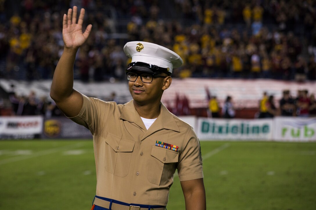 U.S. Marine Corps Sgt. Mattxyrill Vidal, Administration Clerk, 12th Marine Corps District, waves at the audience during the San Diego State University vs. Arizona State University college football game at San Diego County Credit Union Stadium, San Diego, Sept. 15, 2018. Marines were recognized throughout the duration of the game for their patriotic service.