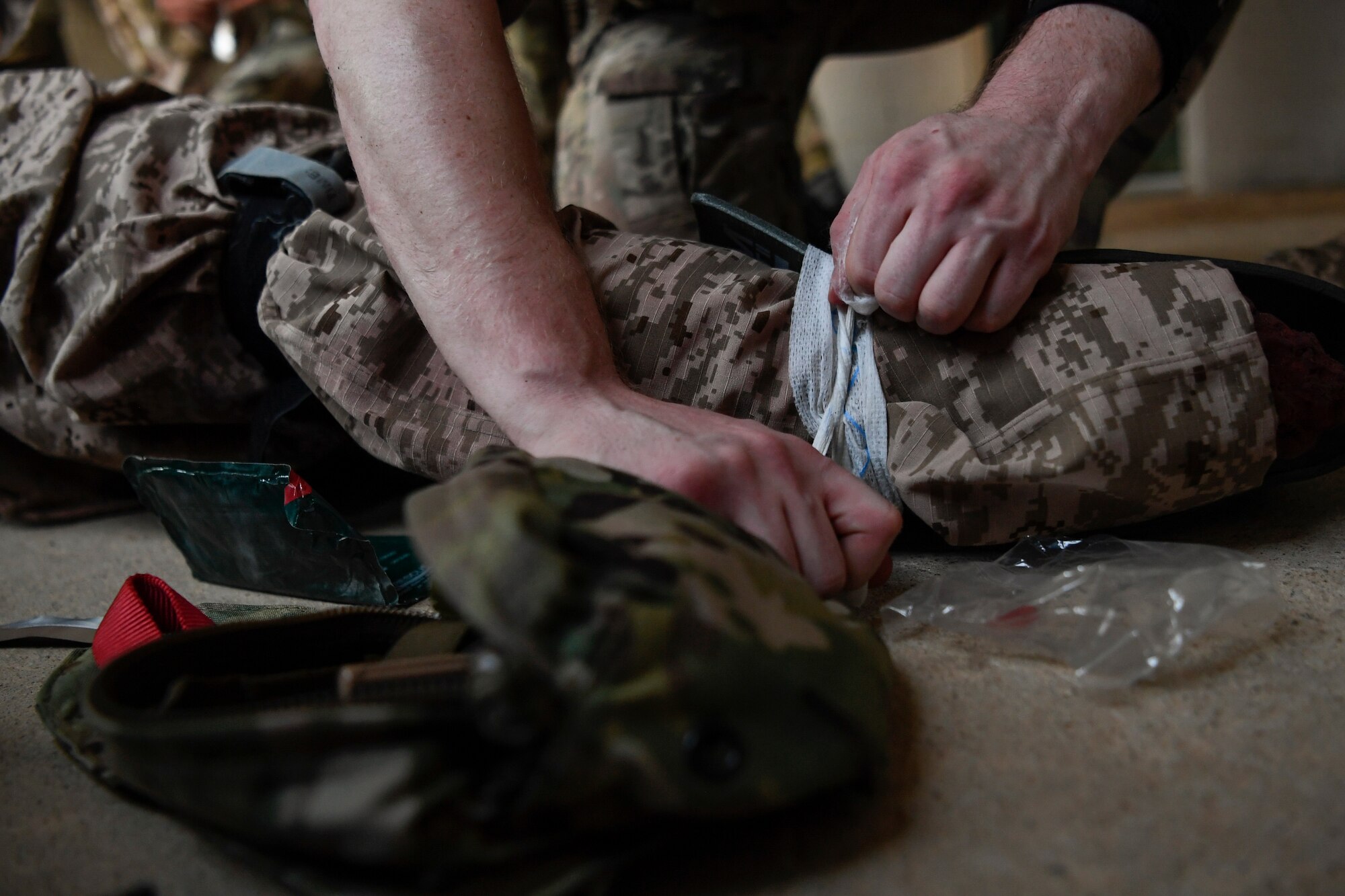Special Tactics Airmen with the 17th Special Tactics Squadron perform medical treatment on a mannequin during medical field training at Fort Benning, Georgia, July 10, 2018.