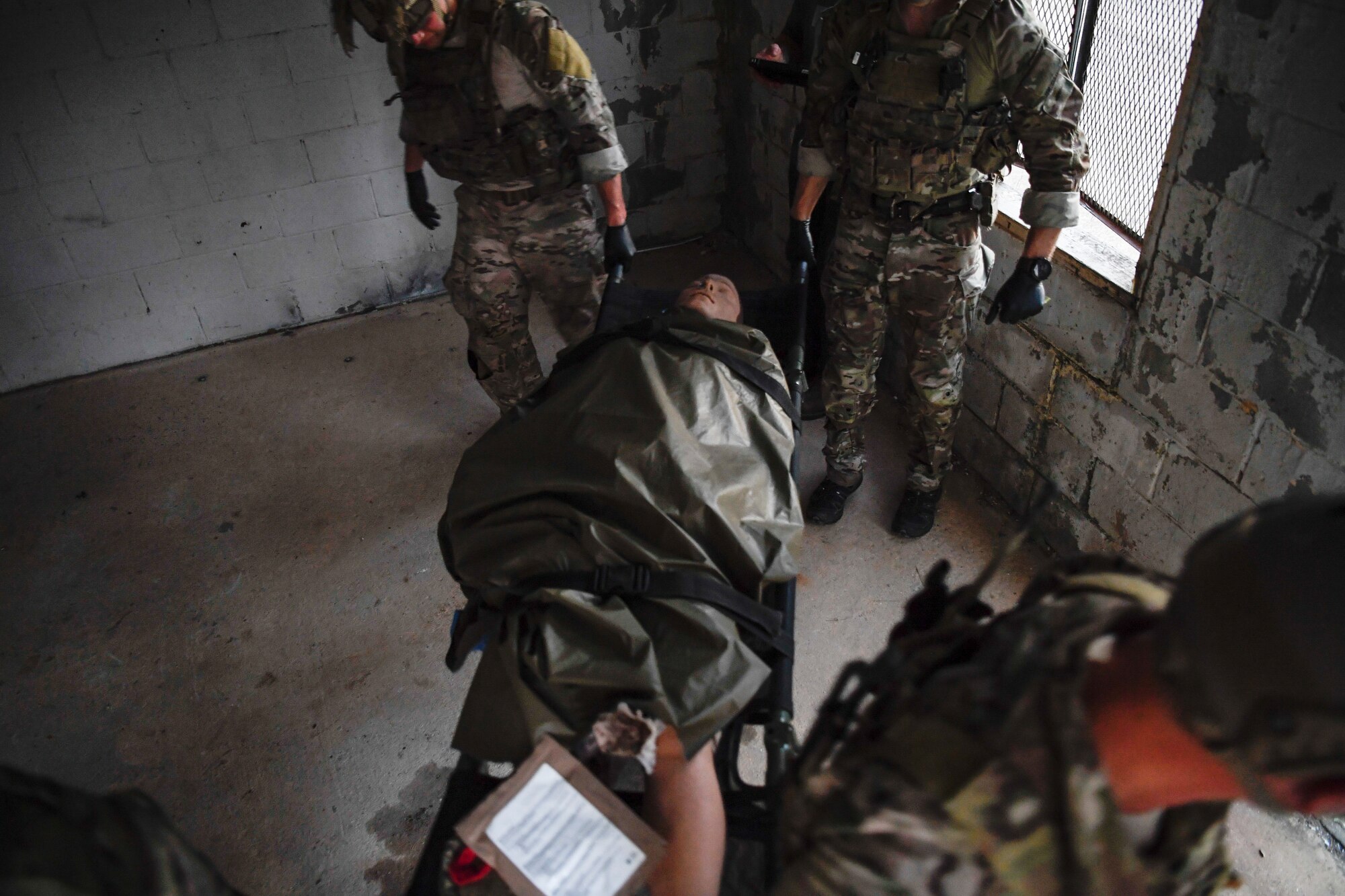 Special Tactics Airmen with the 17th Special Tactics Squadron transport a litter carrying a mannequin during medical field training at Fort Benning, Georgia, July 10, 2018.