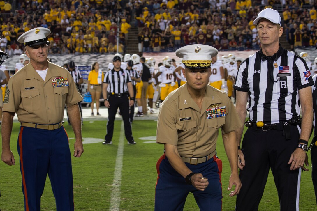 U.S. Marine Corps Col. Terry M. Johnson, center, Commanding Officer, 12th Marine Corps District, tosses the coin during the San Diego State University vs. Arizona State University college football game at San Diego County Credit Union Stadium, San Diego, Sept. 15, 2018. Marines were recognized throughout the duration of the game for their patriotic service.