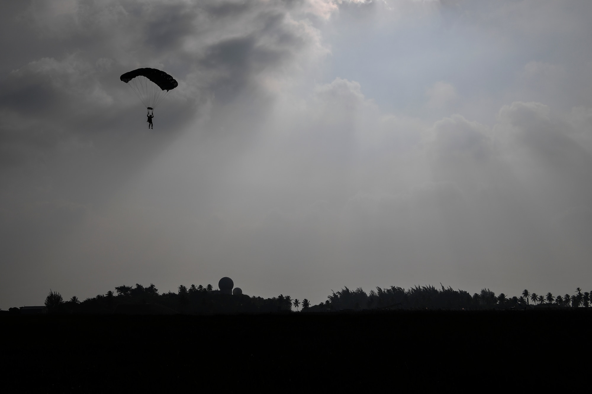 A Special Tactics Airman with the 320th Special Tactics Squadron prepares to land at Kwajalein Atoll, June 19, 2018.