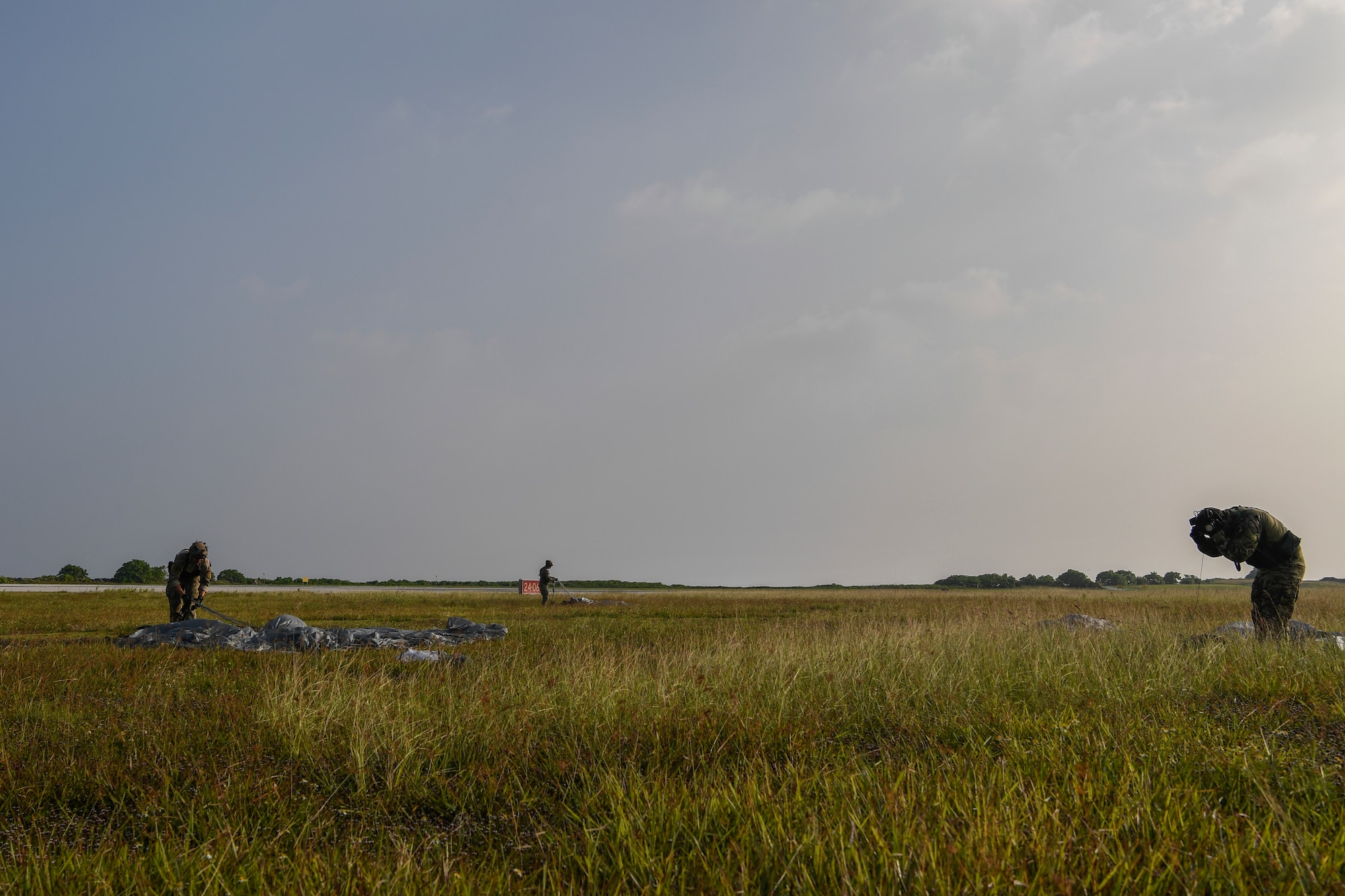 Special Tactics Airmen with the 320th Special Tactics Squadron pack their parachutes following a jump at Kwajalein Atoll, June 19, 2018.