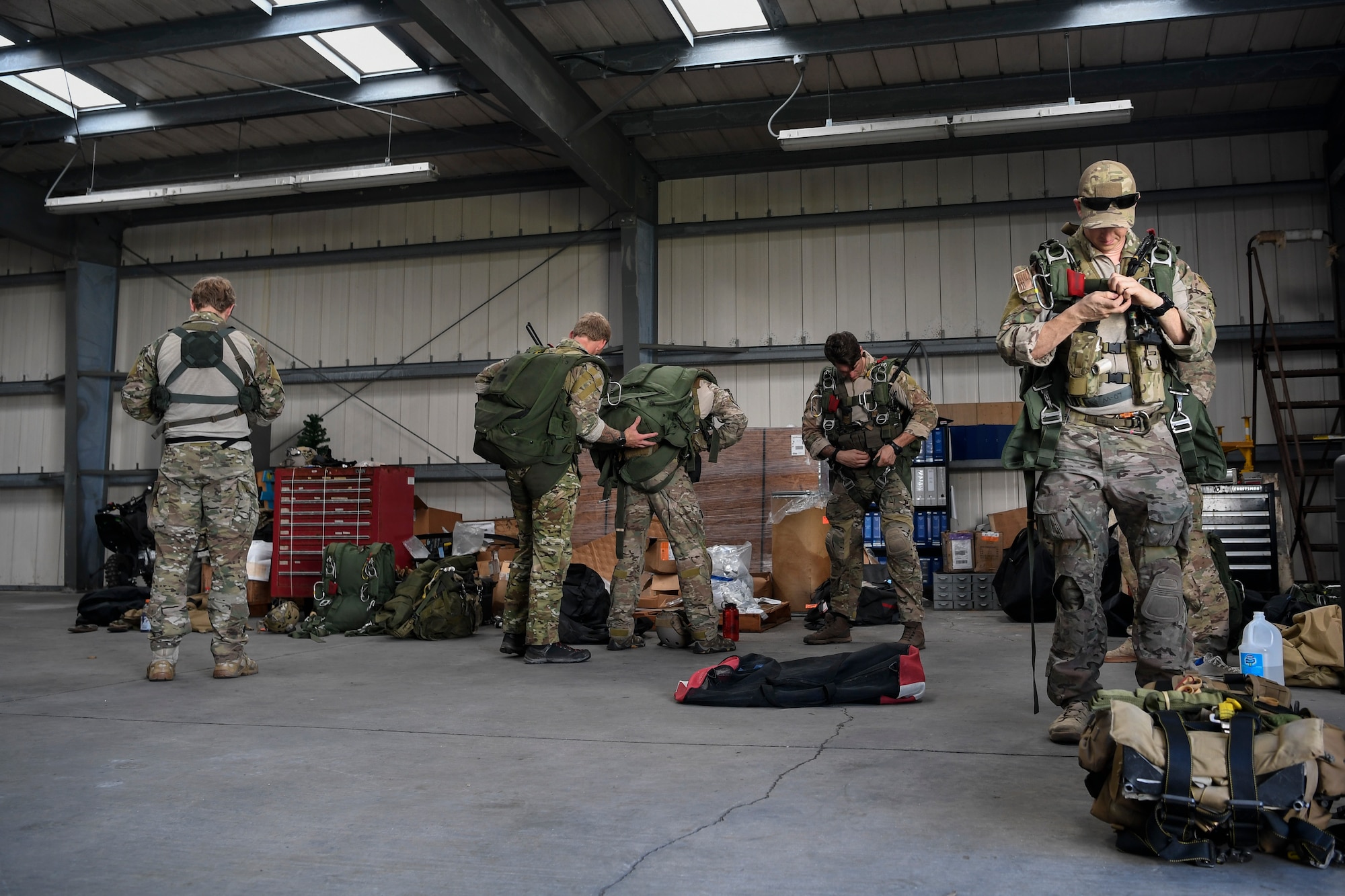 Special Tactics Airmen with the 320th Special Tactics Squadron conduct inspections of gear prior to a jump at Kwajalein Atoll, June 19, 2018.