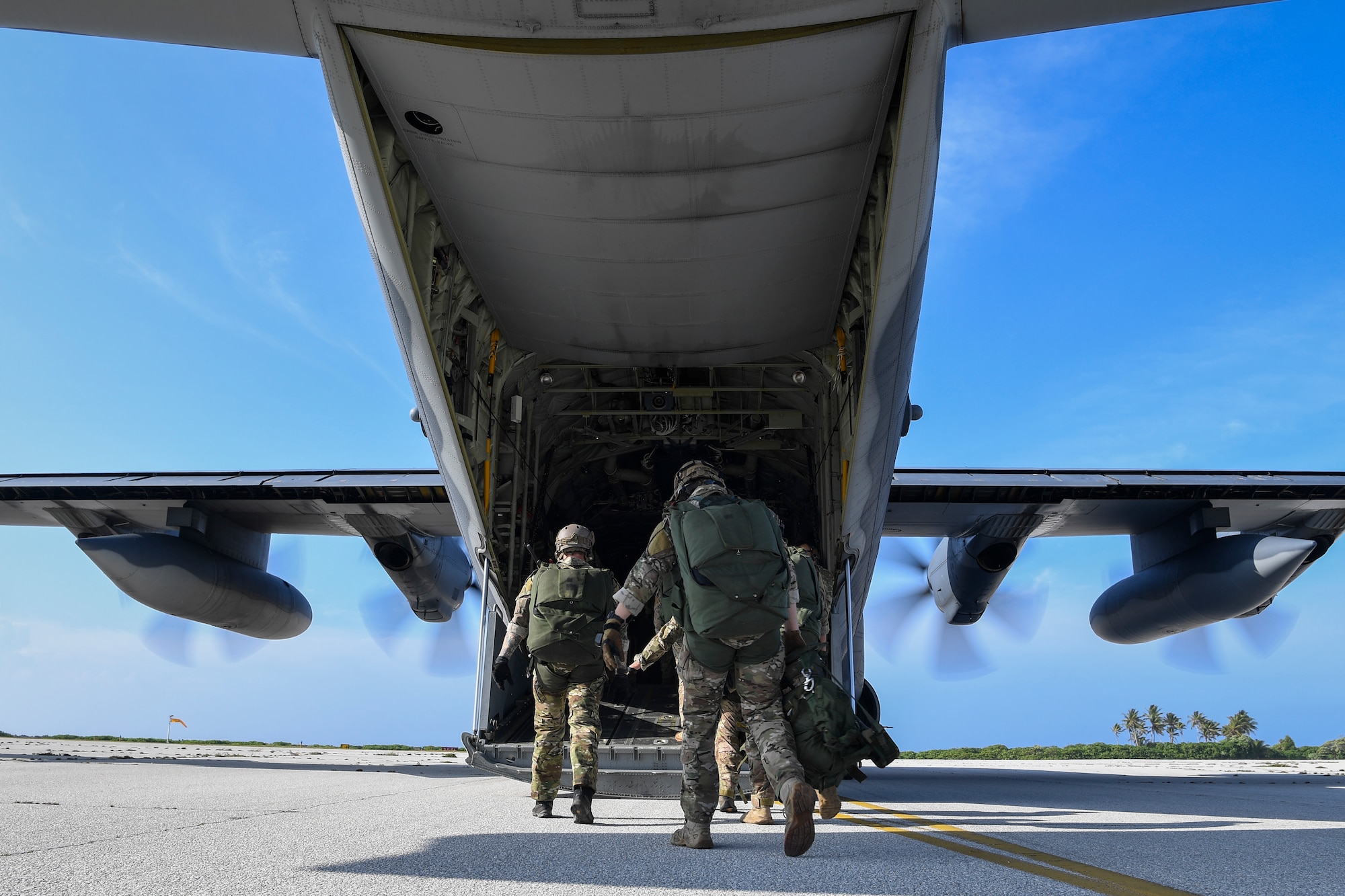 Special Tactics Airmen with the 320th Special Tactics Squadron prepare to board an MC-130J Commando II with the 17th Special Operations Squadron at Kwajalein Atoll, June 19, 2018.