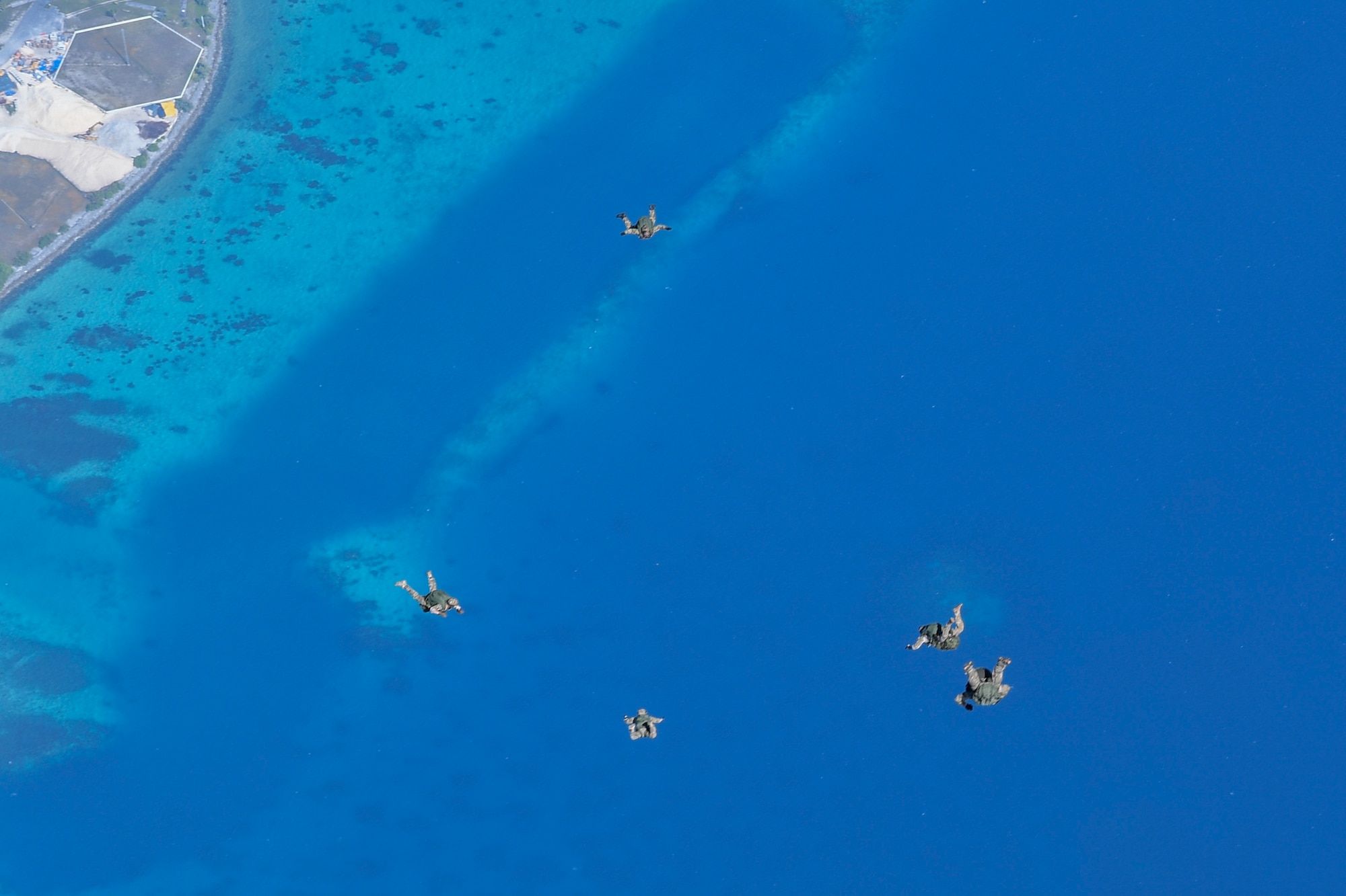 Special Tactics Airmen with the 320th Special Tactics Squadron jump from an MC-130J Commando II with the 17th Special Operations Squadron above Kwajalein Atoll, June 19, 2018.