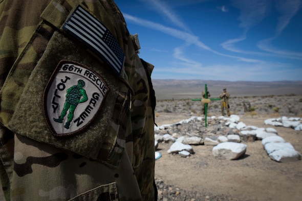 Lt. Col. Joshua Shonkwiler, 66th Rescue Squadron commander, regards a memorial built for fallen members of the 66th RQS August 29, 2018 on the Nevada Test and Training Range. (U.S. Air Force photo by Airman Bailee A. Darbasie)