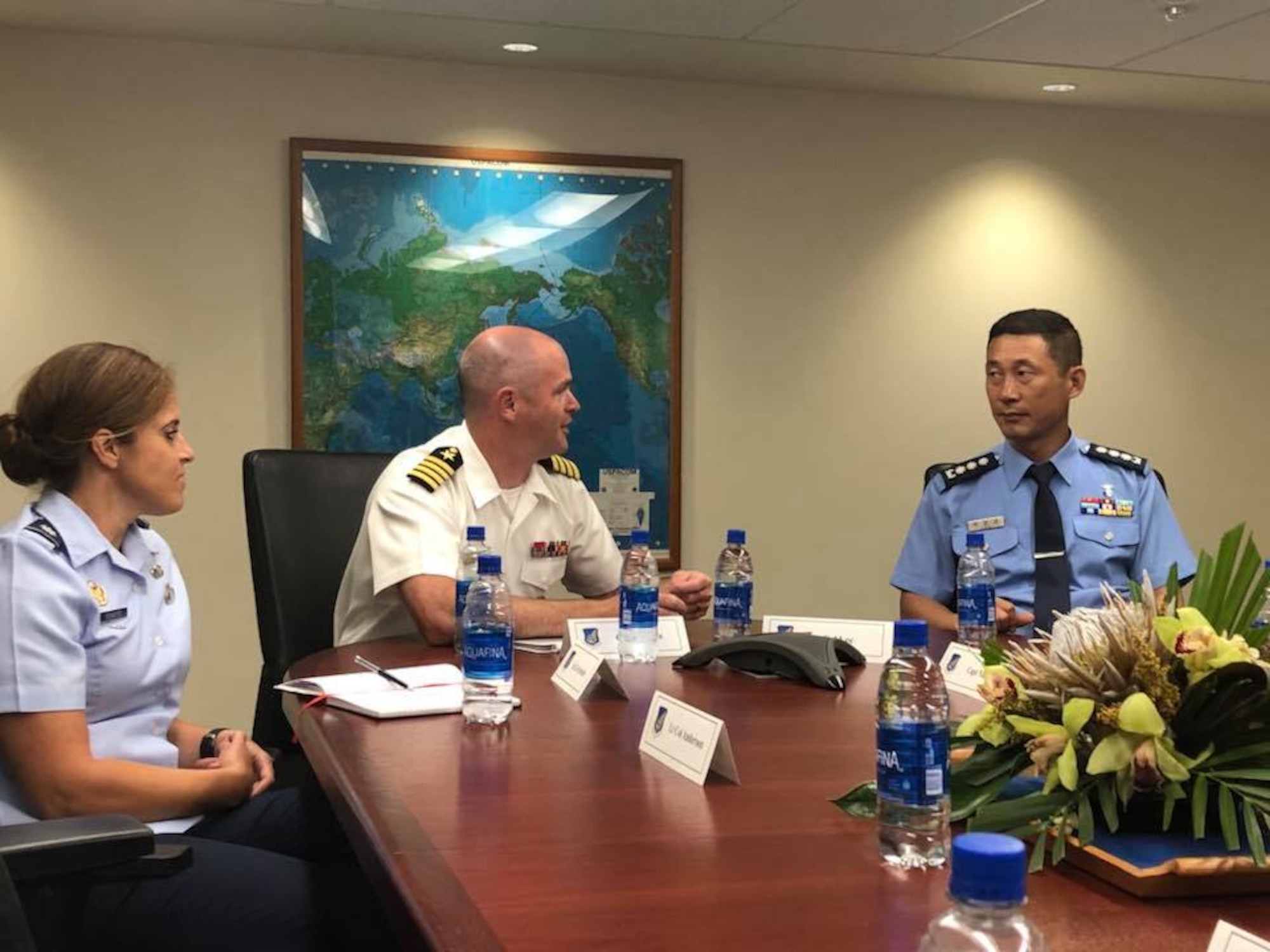 U.S. Navy Capt. William Kafka, Indo-pacific Command Public Affairs Officer and Air Force Lt. Col. Megan Schafer, Pacific Air Forces PA Director brief Republic of Korea Air Force Col. Sang-kyu Lee, Cheif of PA, about the importance of strategic communication at Joint Base Peral Harbor-Hickam, Hawaii Sept. 11, 2018. ROKAF officers visited PACAF/PA to discuss the importance of communicating in an integrated, synchronized, and purposeful way to build a united PA system capable of achieving common operational goals in case of emergencies and bilateral operations. (U.S. Air Force photo by Master Sgt. Nadine Y. Barclay)