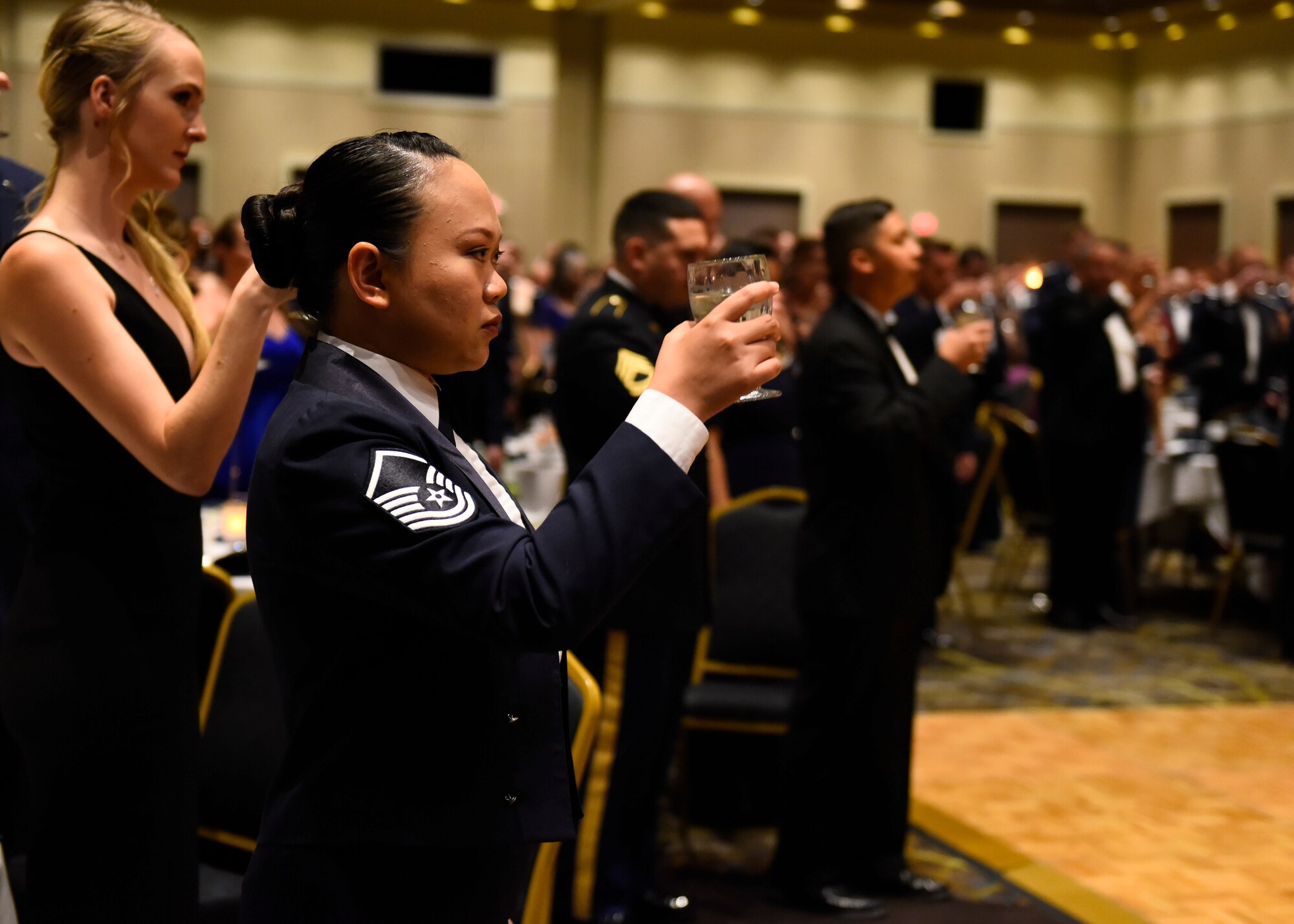 Master Sgt. Cyd Arandia, 92nd Comptroller Squadron flight chief, raises her glass as part of a toast during Fairchild's Air Force Ball at Northern Quest Resort and Casino in Airway Heights, Washington, Sept. 15, 2018. Toasts were made to honor the flag, the president, and all commanders and chiefs of each service branch. (U.S. Air Force photo/Airman 1st Class Lawrence Sena)