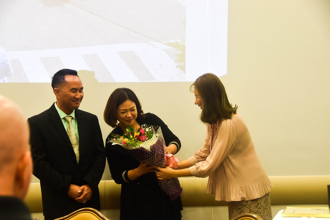 Jamie Hagio, Area Engineer, Humphreys Area office, and his wife receives gifts during his Farewell luncheon held at Taproom restaurant, Camp Humphreys, Sep.12.