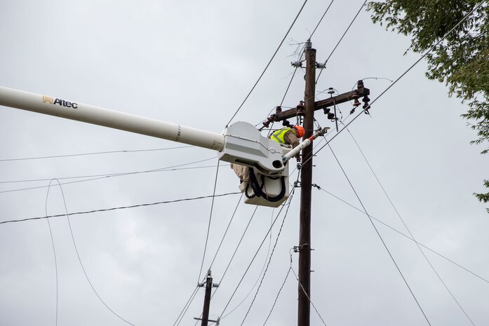 Utility workers with JCL Power Boyce L.A., repair damaged power lines on Marine Corps Air Station New River, N.C., Sept. 16, 2018. Hurricane Florence impacted Marine Corps Base Camp Lejeune and MCAS New River with periods of strong winds, heavy rains, flooding of urban and low lying areas, flash floods and coastal storm surges.  (U.S. Marine Corps photo by Lance Cpl. Damaris Arias)