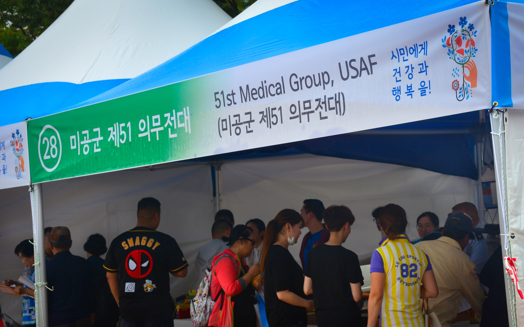 Guests visit a booth set up by the 51st Medical Group during the Pyeongtaek Health Festival in Pyeongtaek, Republic of Korea, Sept. 16, 2018.