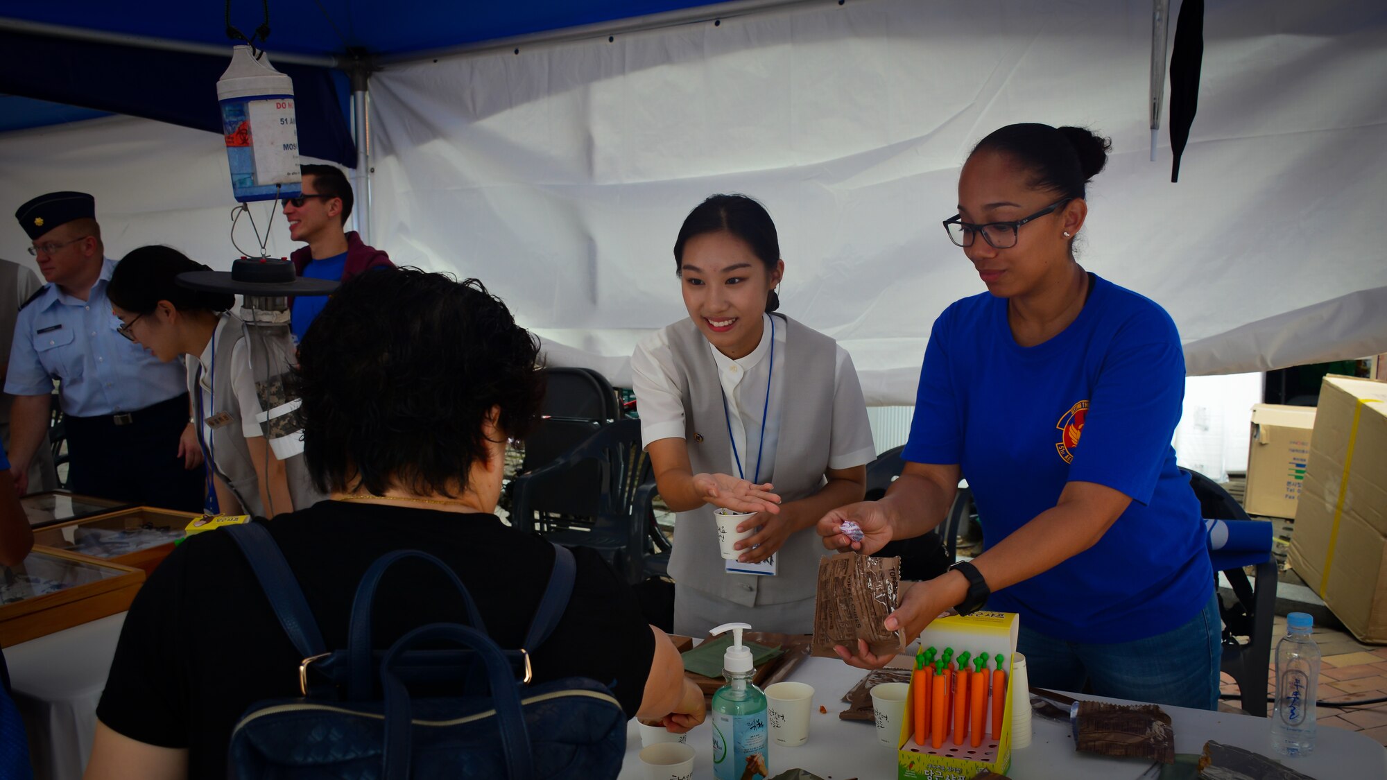 Members of the 51st Aerospace Medicine Squadron Public Health flight and students from local high schools show visitors an U.S. military field ration at the Pyeongtaek Health Festival in Pyeongtaek, Republic of Korea, Sept. 16, 2018.