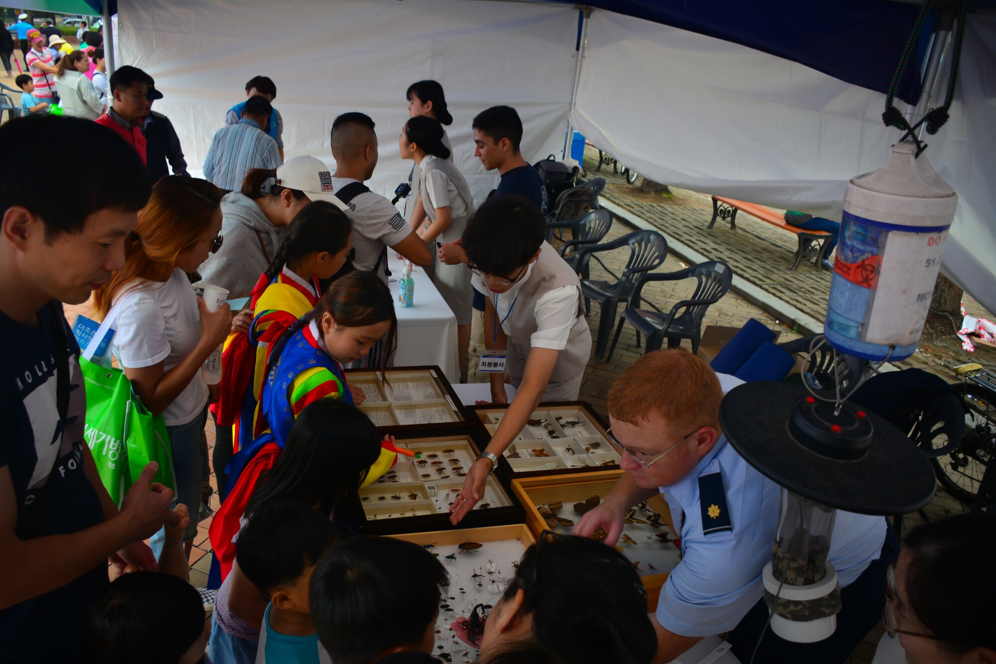 Members of the 51st Aerospace Medicine Squadron Public Health flight, Bio-environmental Engineering flight, and students from local high schools show visitors an U.S. military field ration at the Pyeongtaek Health Festival in Pyeongtaek, Republic of Korea, Sept. 16, 2018.