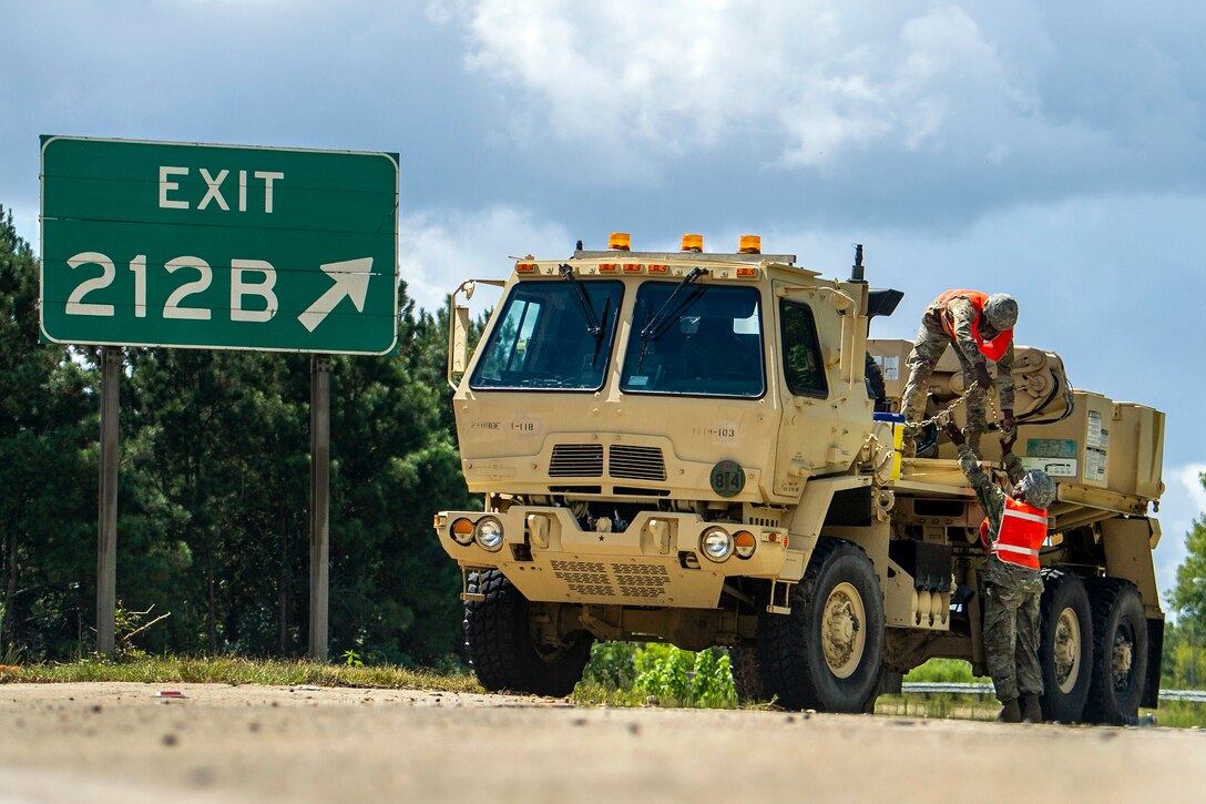 Soldiers stage recovery equipment to provide support for disabled vehicles.