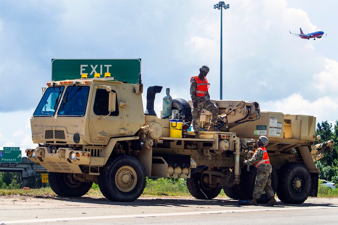 Soldiers stage recovery equipment to provide support for disabled vehicles.